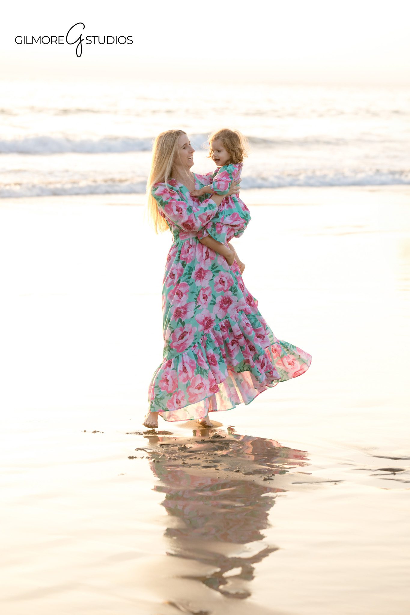 Newport Pier portrait showing family framed under wooden beams.

Photographer capturing candid toddler expression during beach session.