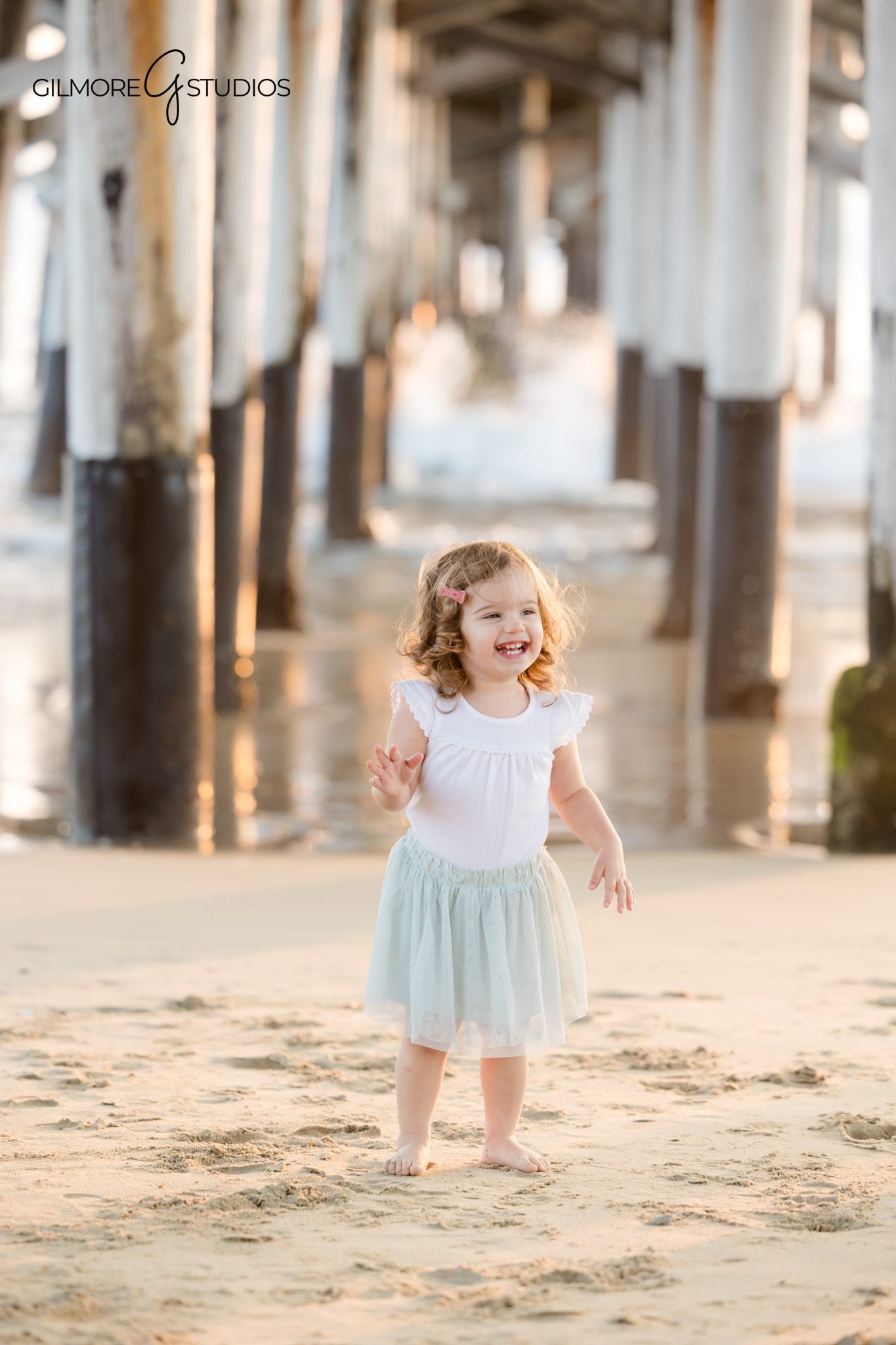 Newport Pier portrait showing mother and child close-up moment.

Photography capturing father and toddler laughing beside the ocean.