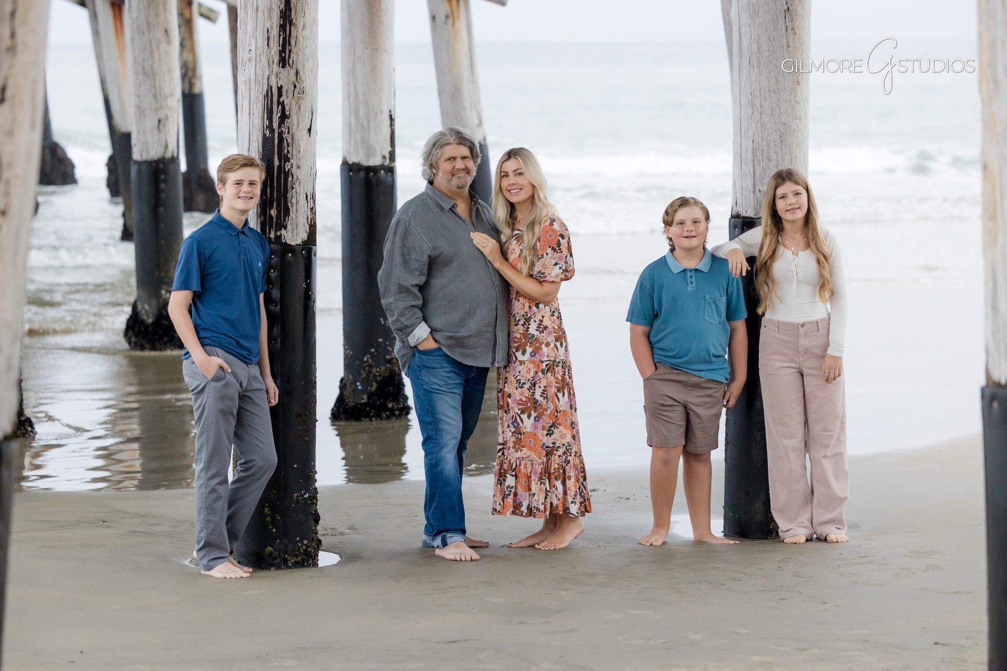Newport Pier family photographer capturing playful toddler moments.

Parents lifting toddler during Newport Beach mini session portrait photography.