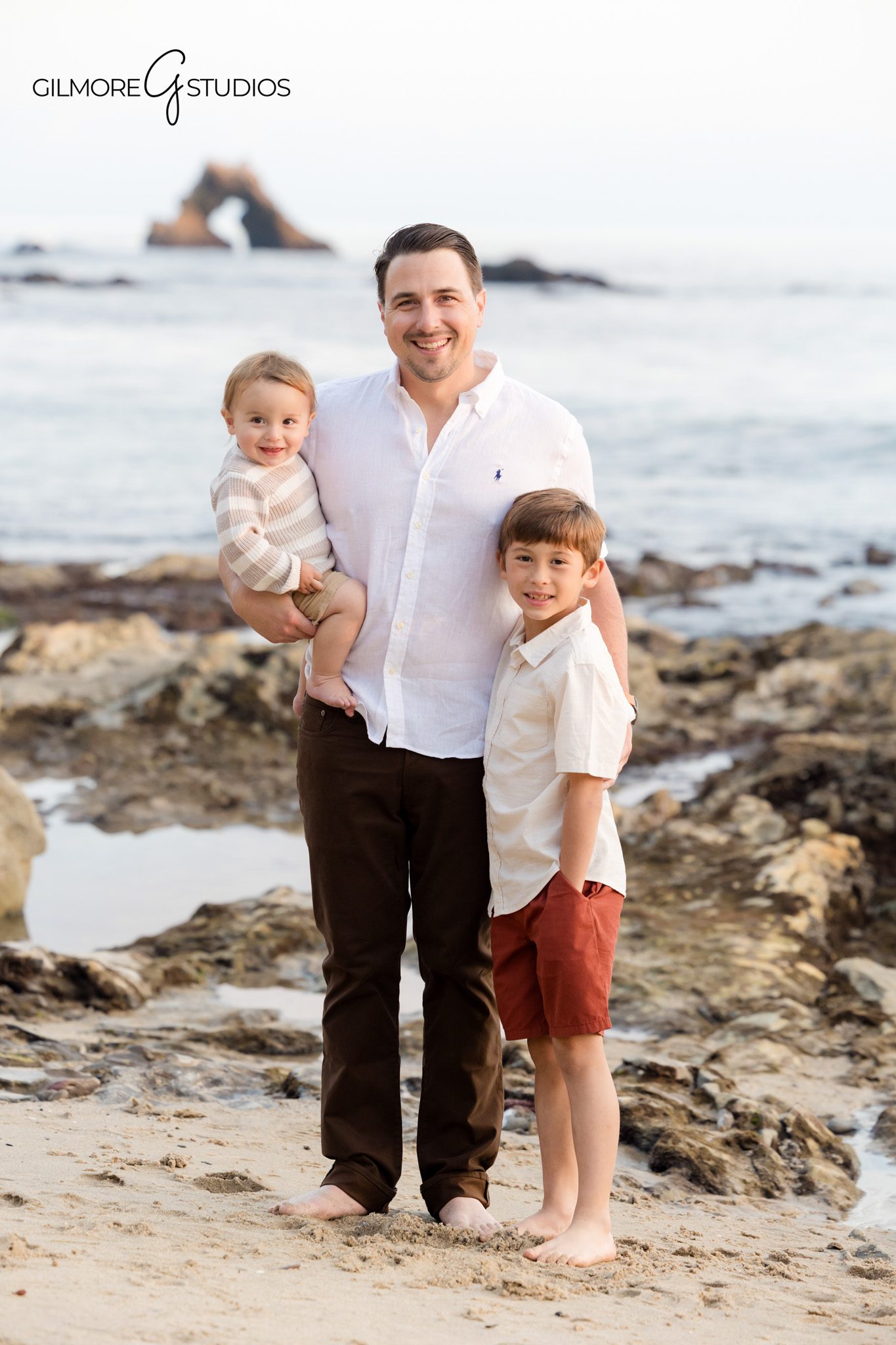 Professional family photographer capturing golden hour mini session at Little Corona.

Beach family photography showing parents walking with children at Little Corona Beach.