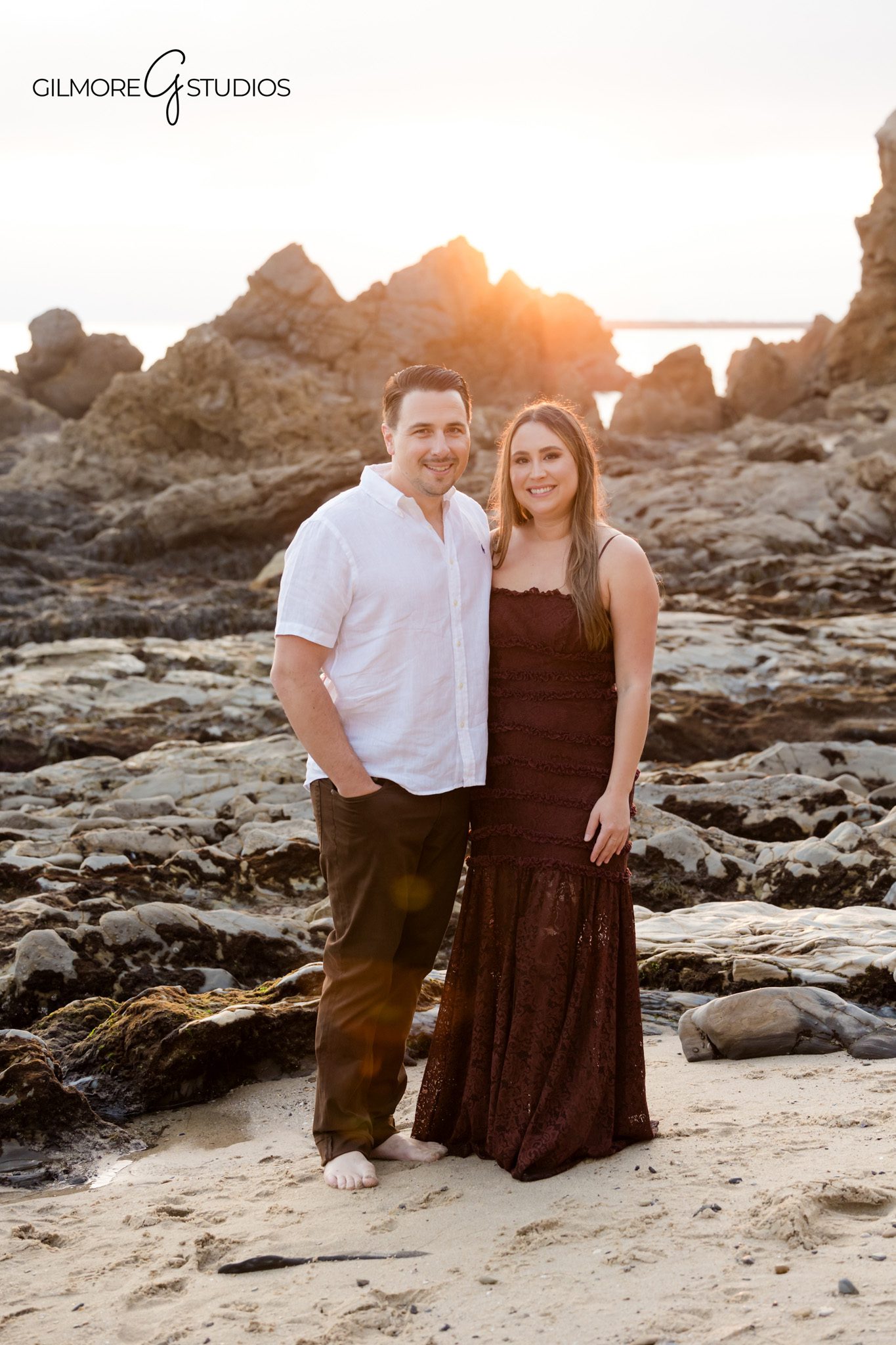 Beach family mini session photography with parents lifting their children.

Little Corona Beach photographer capturing warm sunset family portraits.