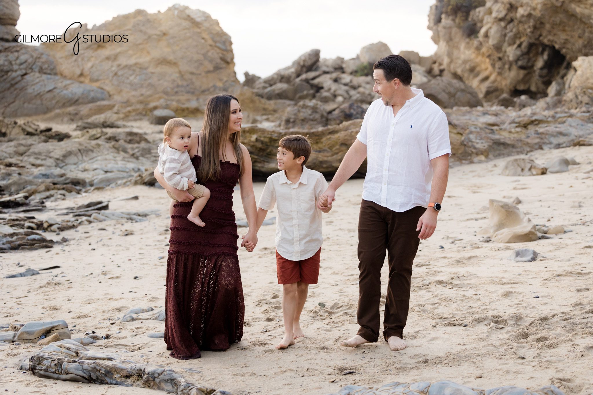 Family photography mini session featuring toddlers playing near the shoreline.

Newport Beach family photographer capturing siblings laughing during beach mini session.