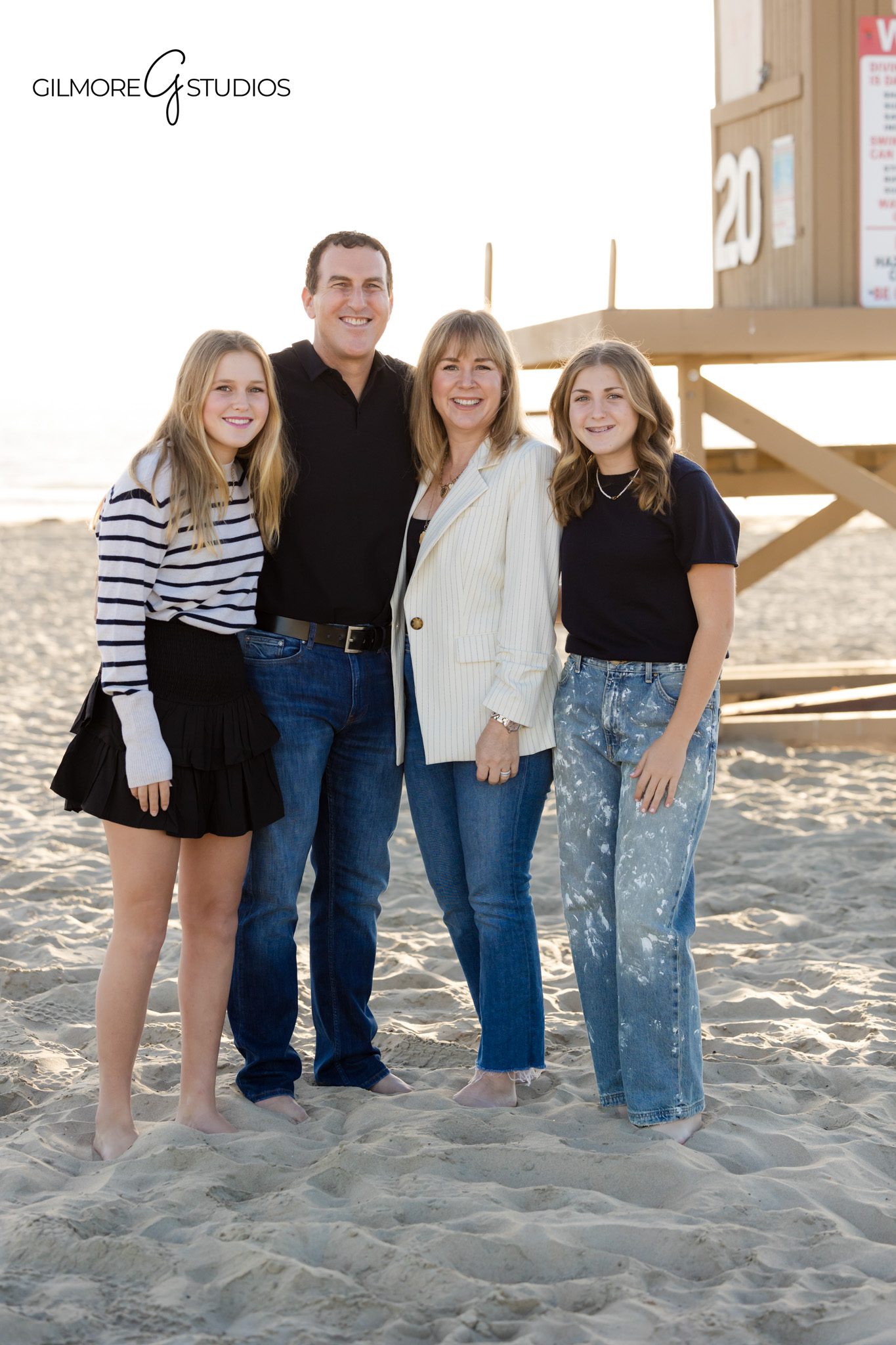 Beach family portrait photography with teen girls at Newport Pier California
Newport Beach family photographer capturing a beach session with teen daughters