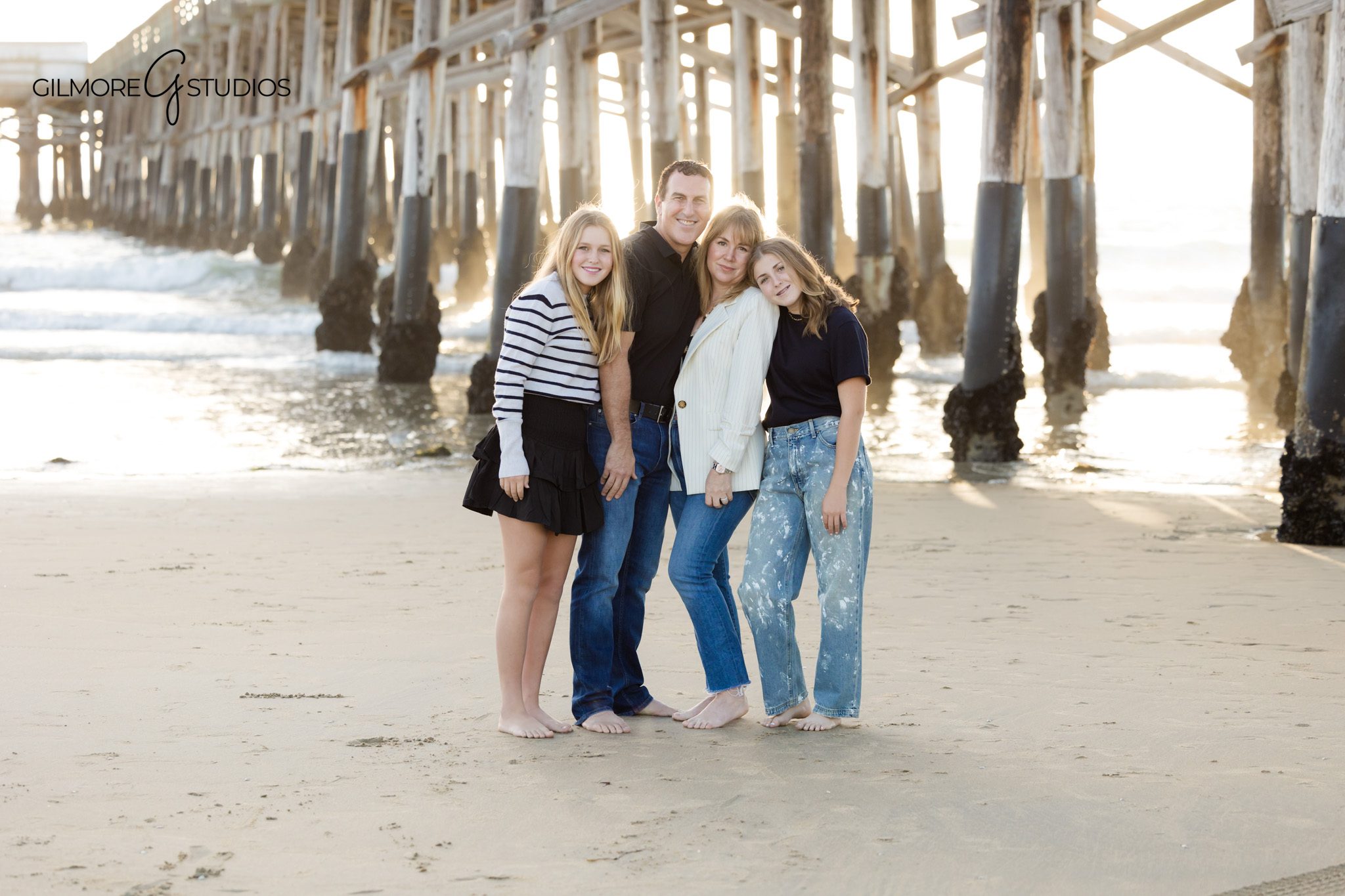 Beach family photography session with teen girls photographed professionally
Newport Pier family portrait photography with relaxed coastal styling