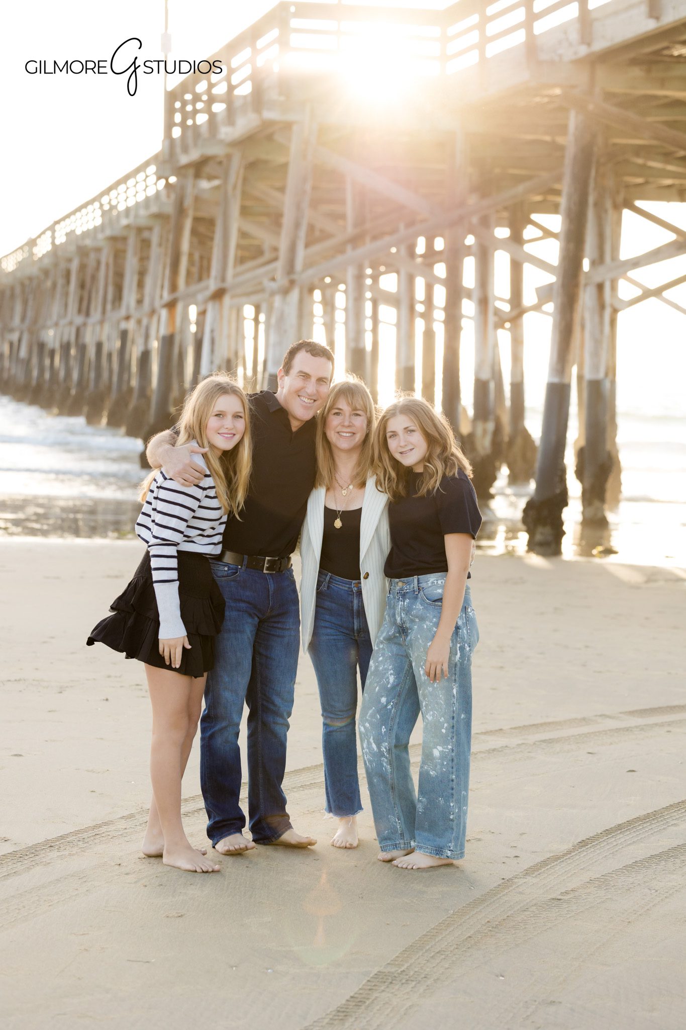 Family photography at Newport Pier featuring parents and teen girls
Coastal family portrait photography with teens photographed at Newport Pier