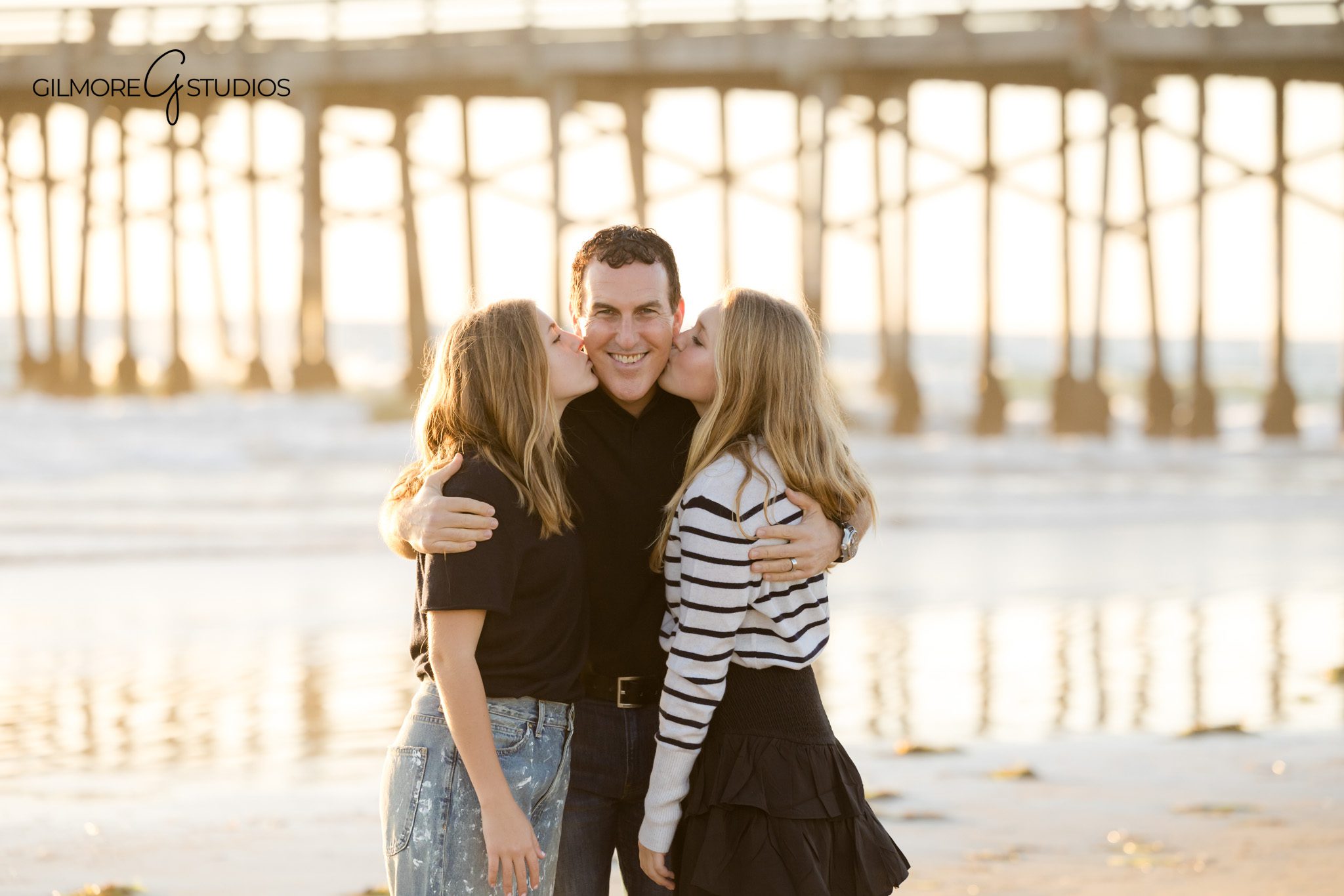 Beach family photography Newport Pier featuring teen daughters
Teen family portrait photography session with natural interaction at the beach