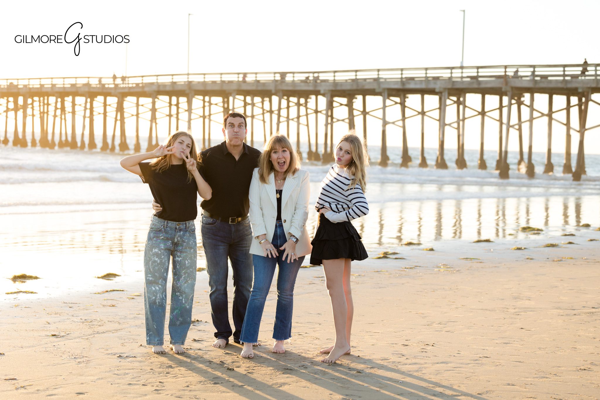 Teen family photography captured by a Newport Beach family photographer
Family portrait photography session with teens at Newport Pier beach