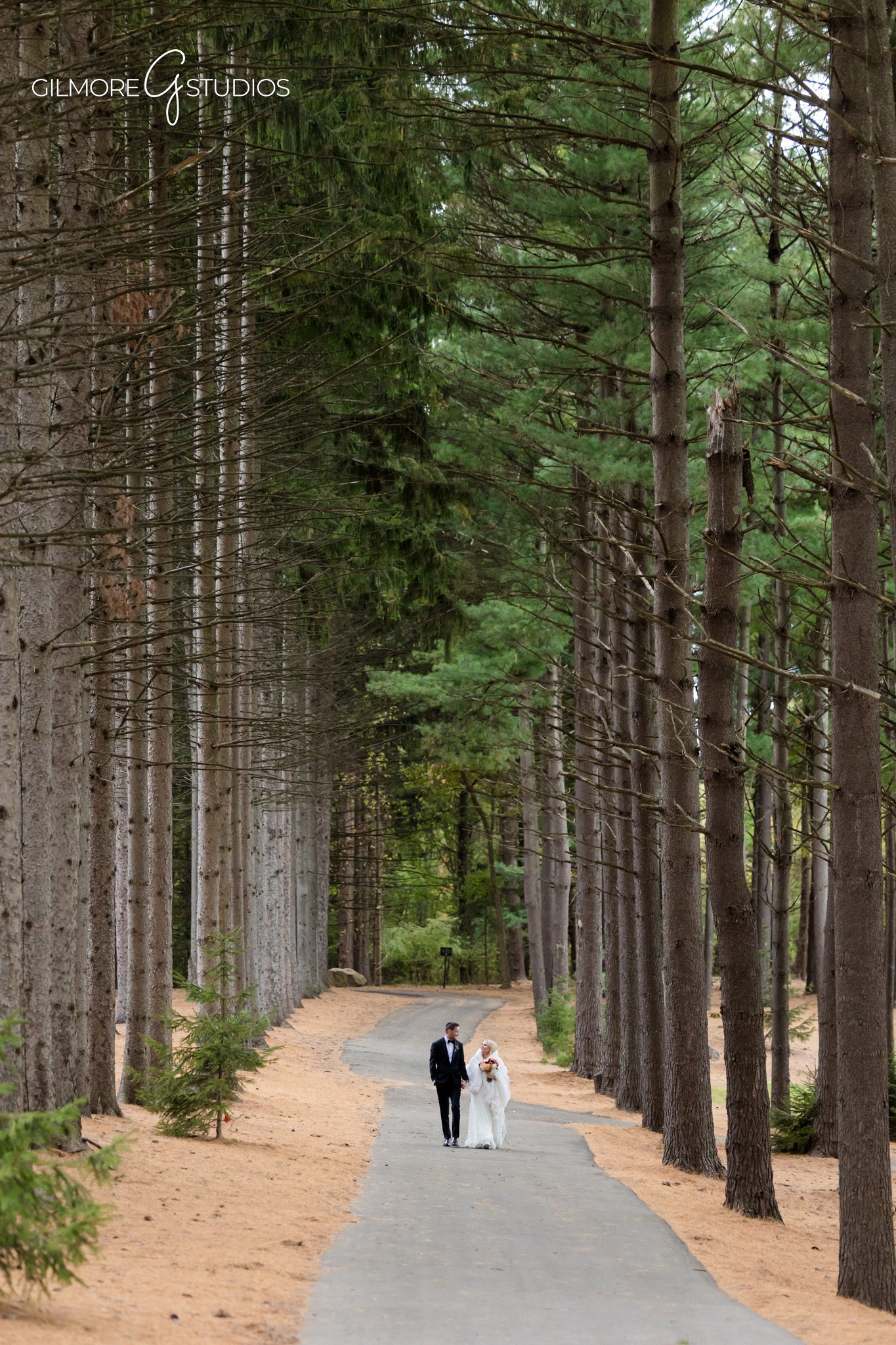 Groom portrait with elegant boutonniere details.

Romantic couple photography during soft sunset haze.
