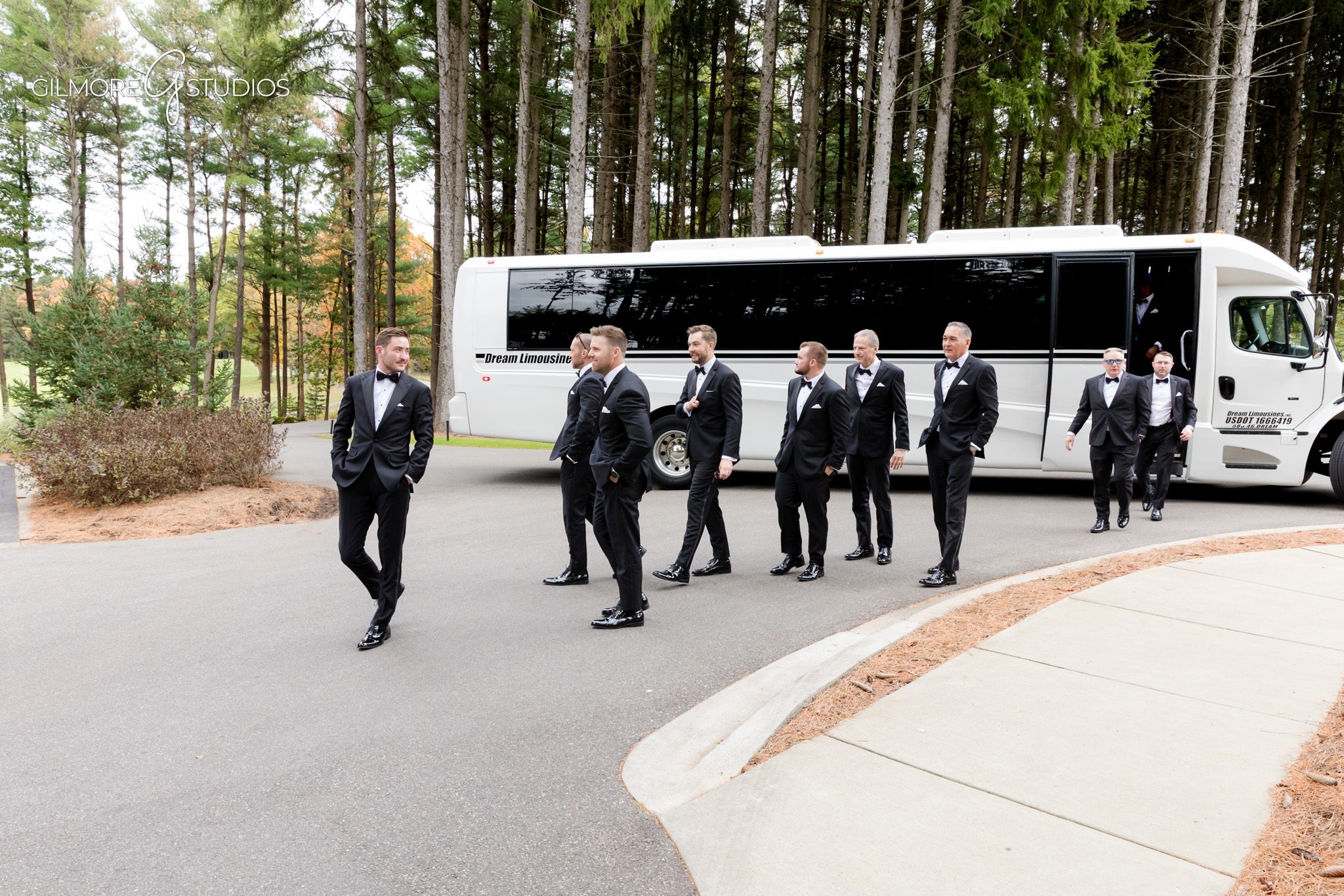 Bride portrait photographed beside large windows of Shepherd’s Hollow.

Groom portrait photography featuring classic black tux in forest setting.