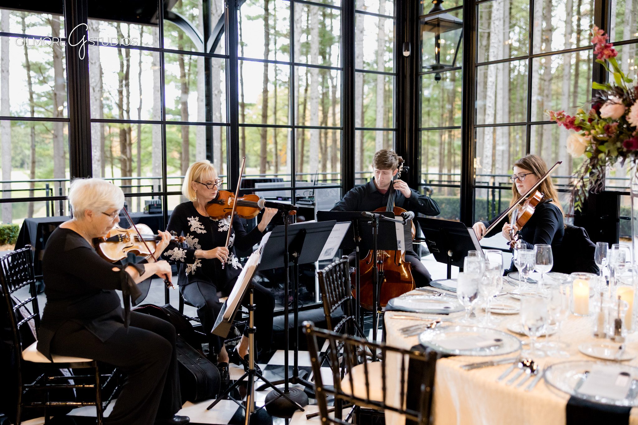 Wedding party portraits at Michigan forest venue.

Candid wedding photography of couple during cocktail hour.