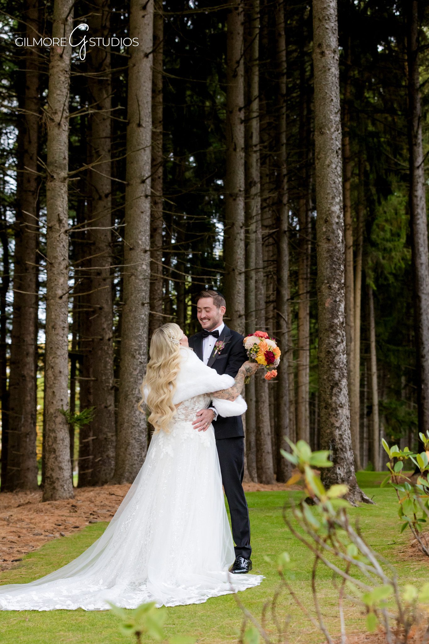 Destination photographer documenting elegant Michigan wedding ceremony outdoors.

Bride portrait photography surrounded by tall pine trees in Michigan.