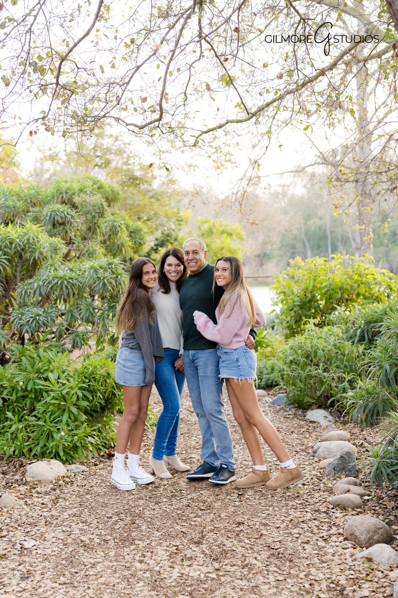 Professional family photographer photographing siblings at Huntington Beach Library.

Outdoor family portrait photography near HB Central Library fountain.
