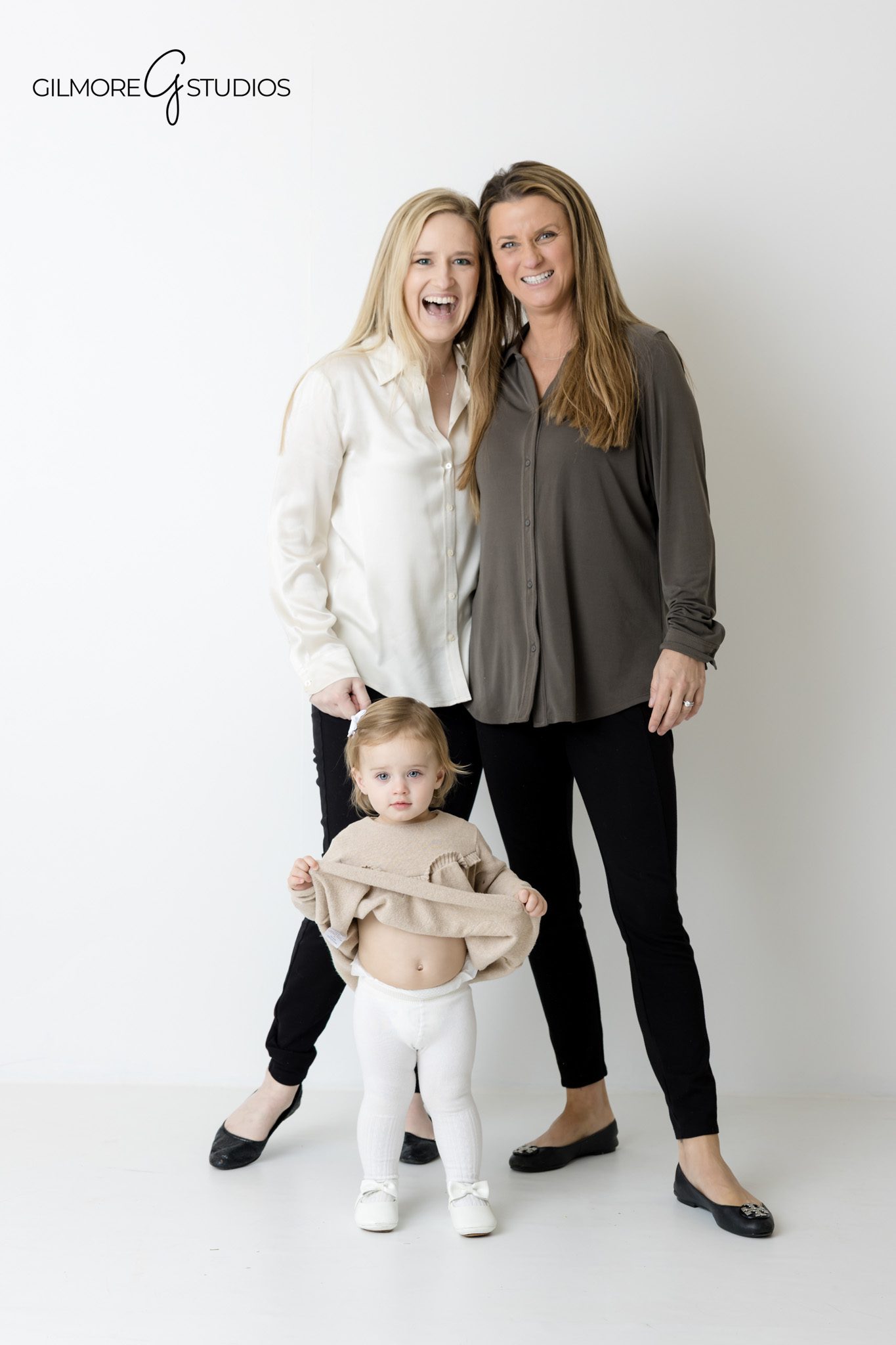 Studio photographer capturing modern family portraits with clean white look.

Orange County family photographer photographing classic white studio portrait.