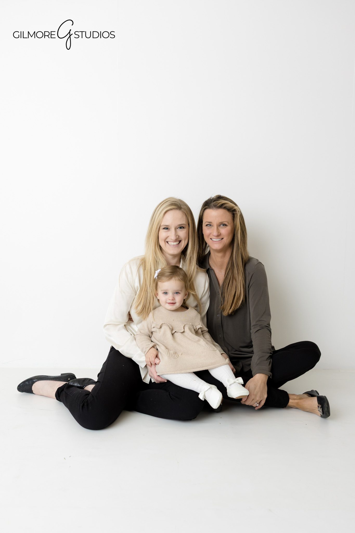 White background portrait photography featuring smiling family group.

Studio photographer capturing playful family moment on white backdrop.