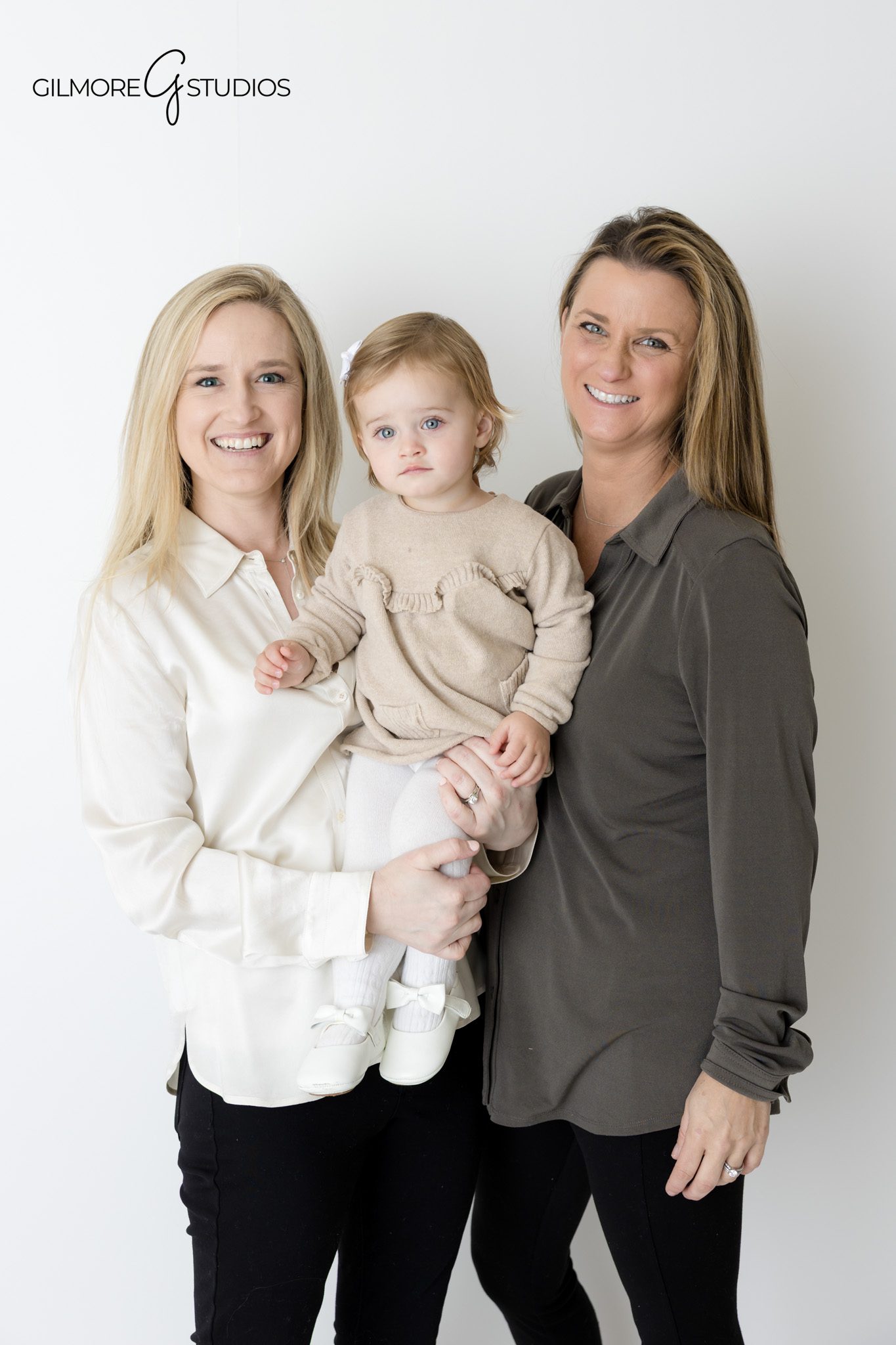 Studio portrait of parents and newborn on white background.

Orange County photographer capturing timeless family studio portrait.