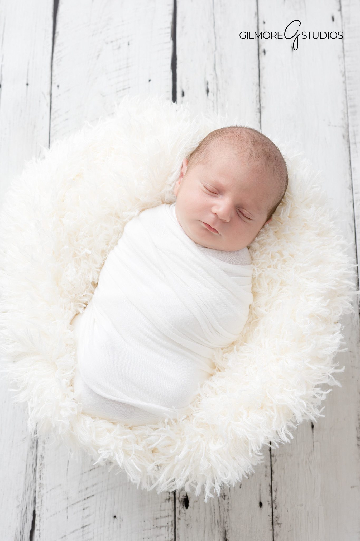 Lifestyle newborn photography of sleeping baby in neutral tones.

Gilbert newborn portrait with close up of tiny hands.