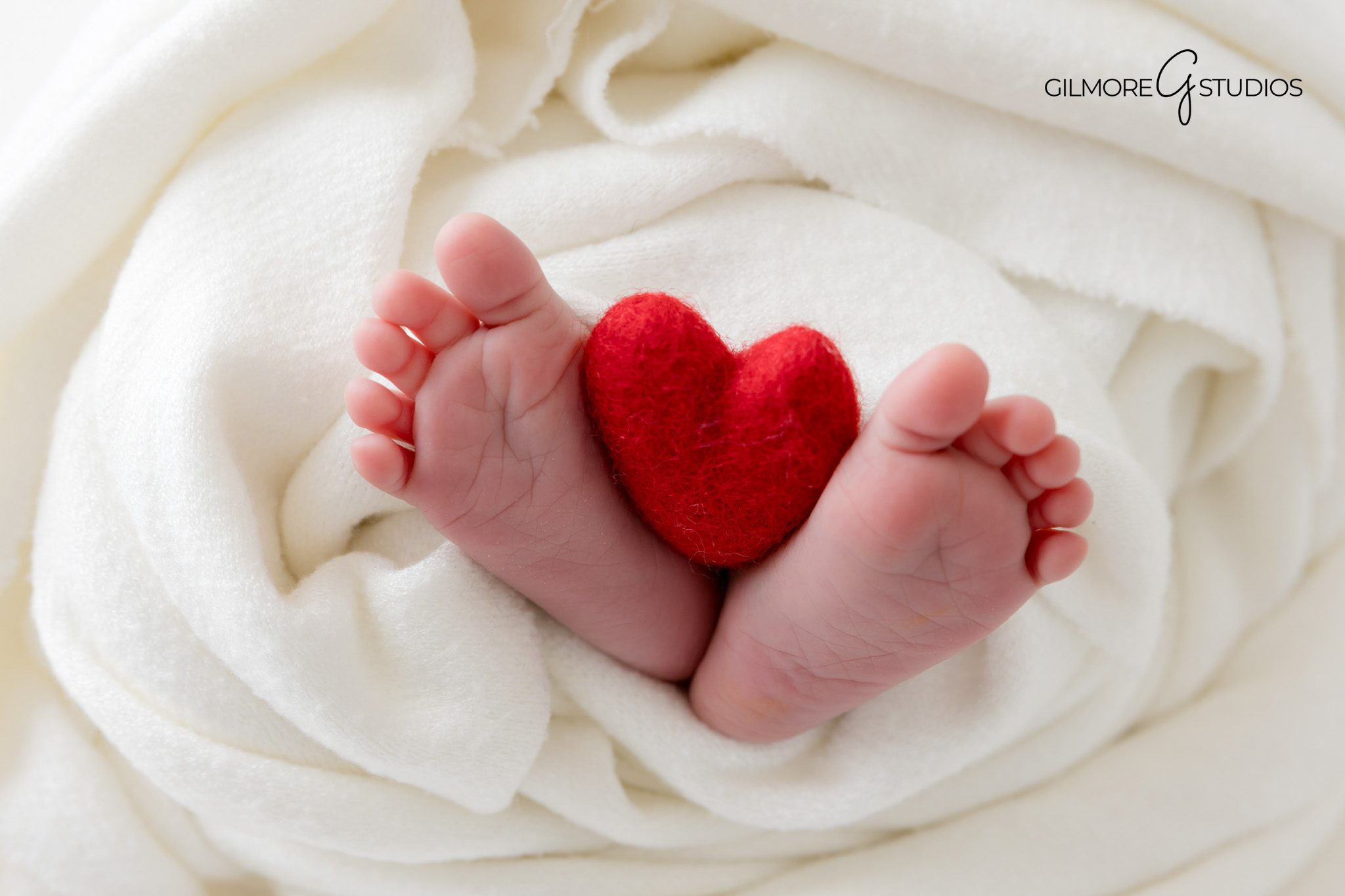 Newborn photography studio in Gilbert capturing clean white setup.

Arizona photographer capturing swaddled newborn in gentle pose.