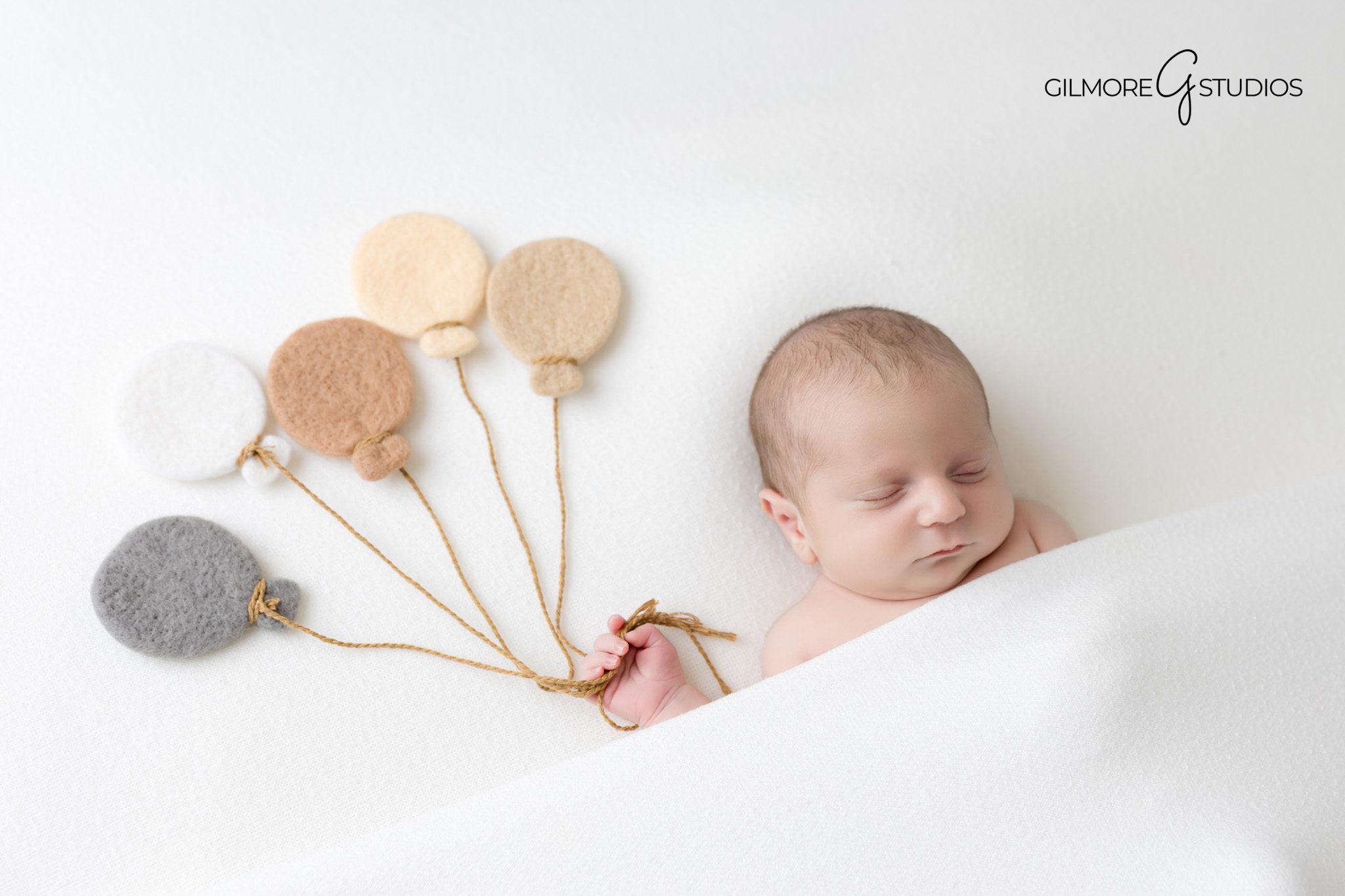 Baby photography showing newborn asleep in curled pose.

Gilbert newborn photographer creating timeless family portraits.