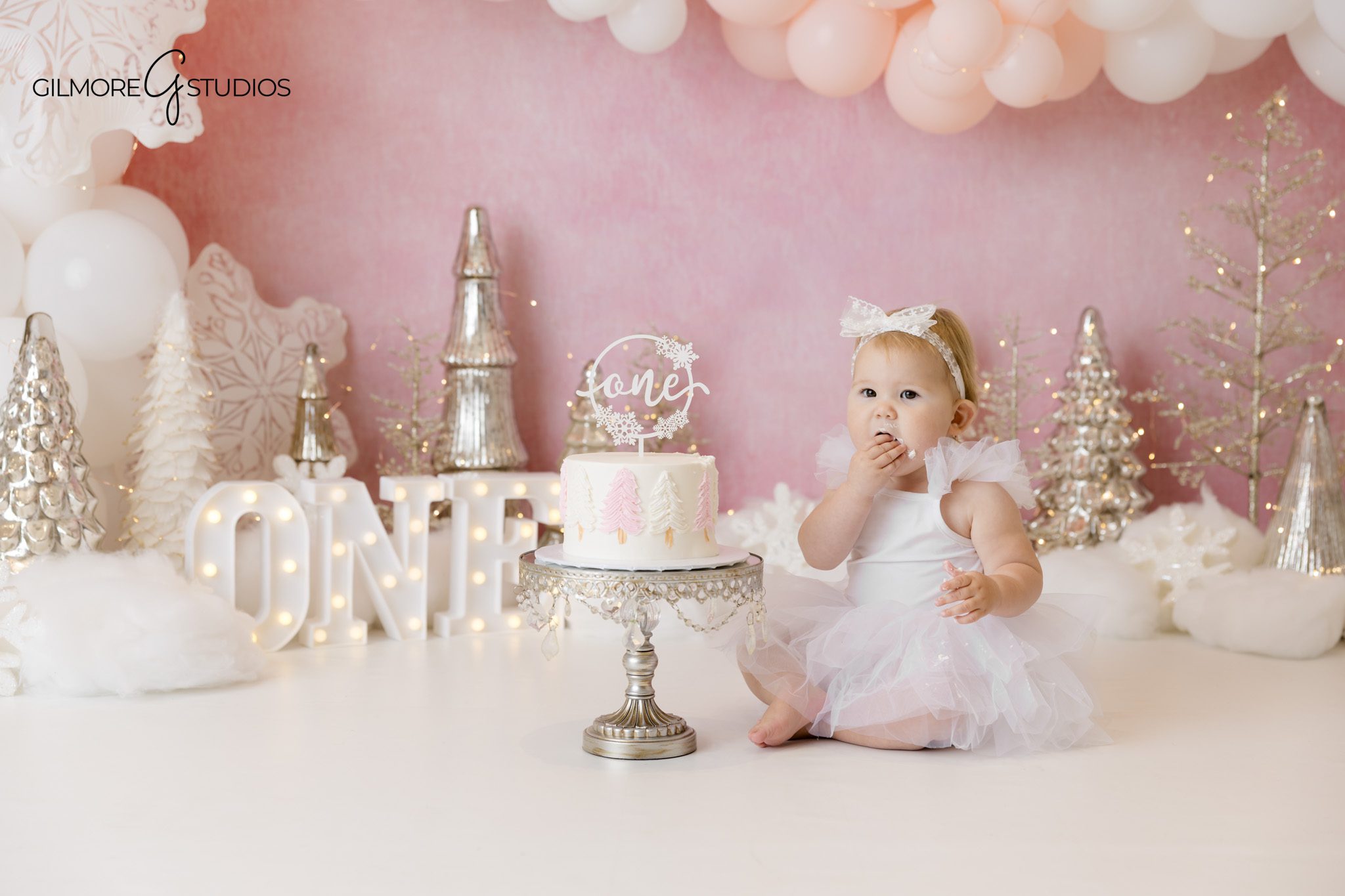 Winter Wonderland cake smash portrait with baby interacting with cake photographed professionally

Snow themed cake smash photography by a Newport Beach first birthday photographer