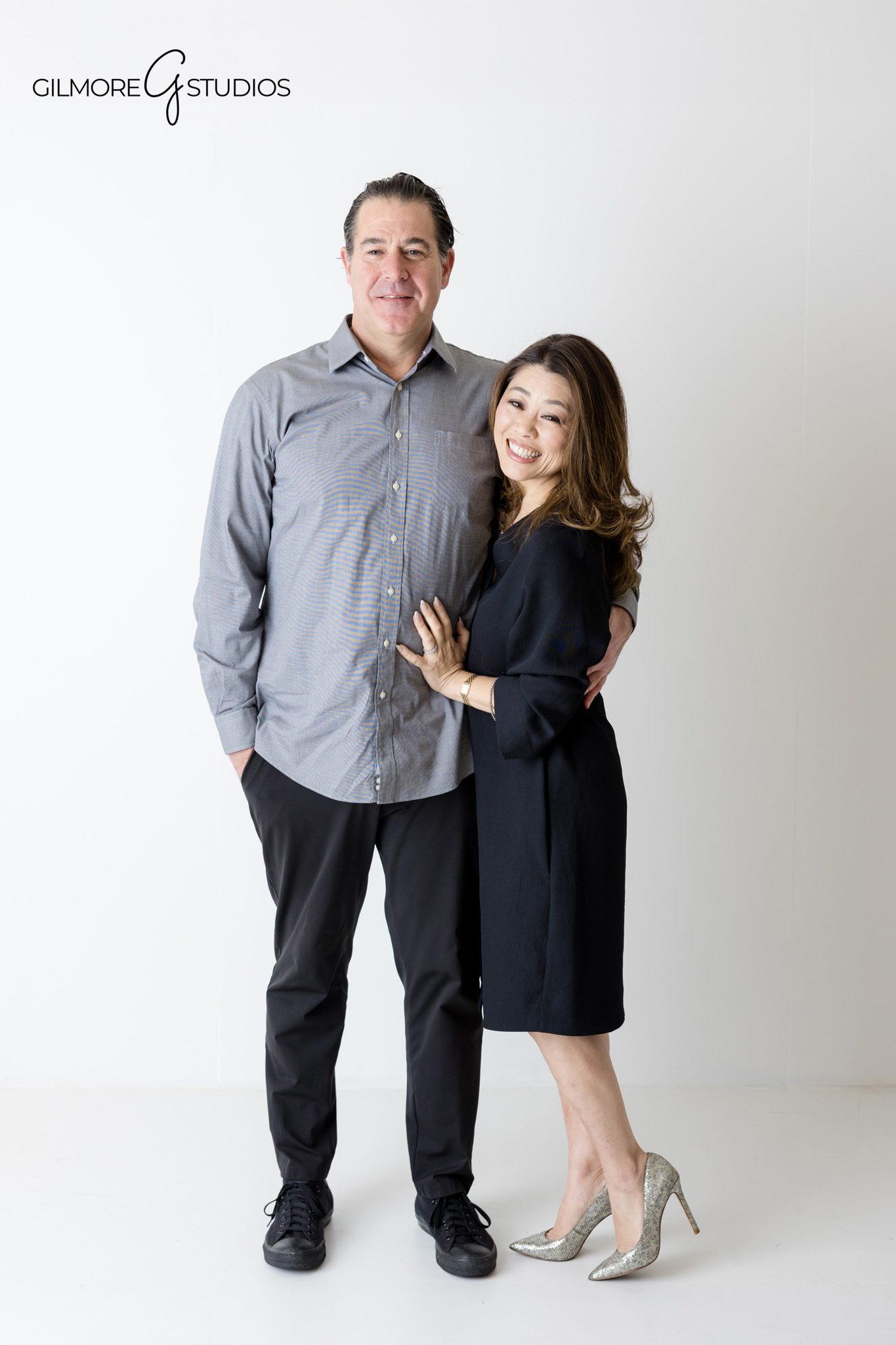 White background family portrait featuring authentic expressions

Studio family photography session photographed by a professional photographer