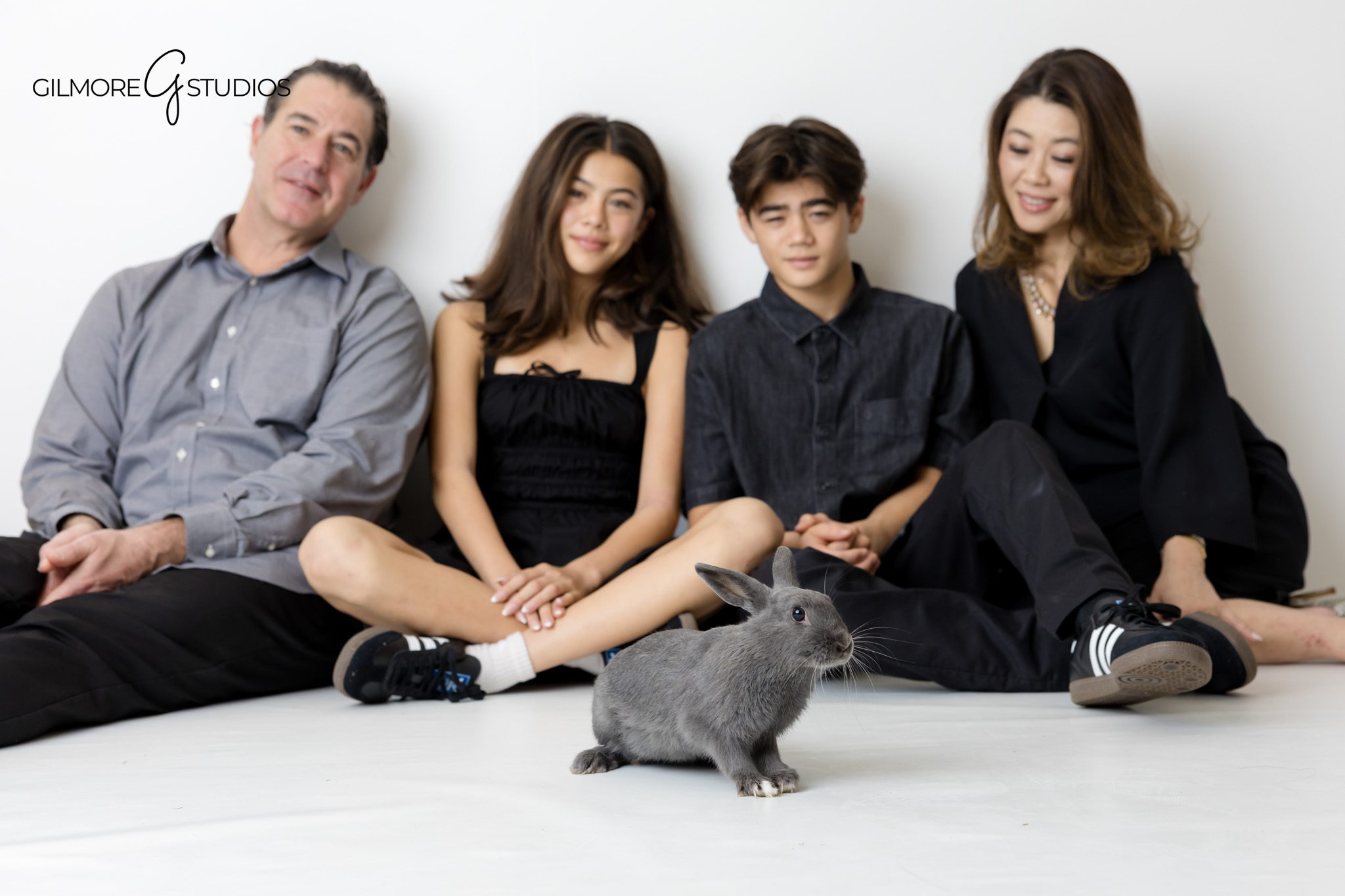 White backdrop family portrait photographed by a studio family photographer

Studio family photography capturing connection on a white background