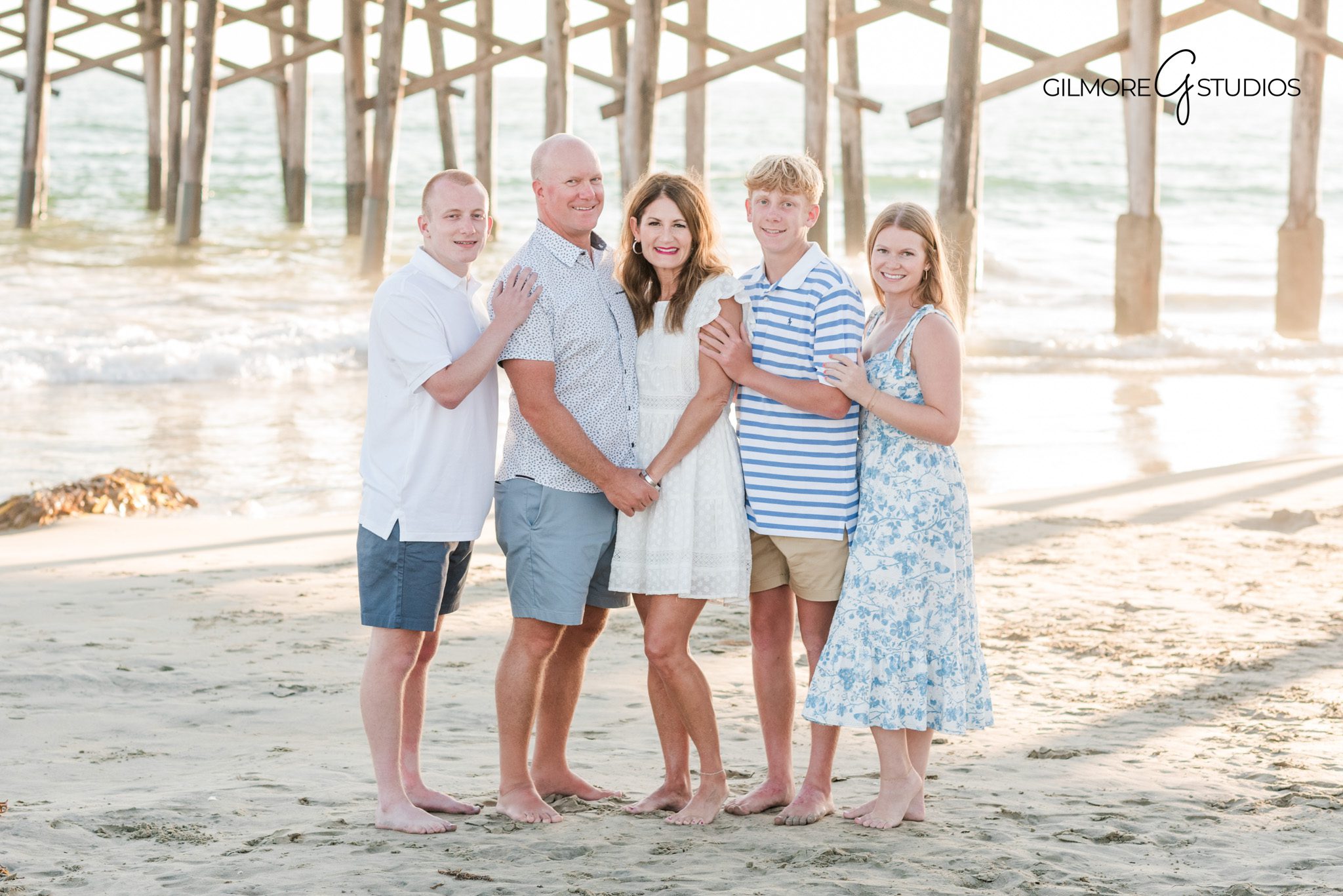 Newport Beach family photography featuring parents and children at the pier
Professional family photographer capturing candid moments at Newport Pier