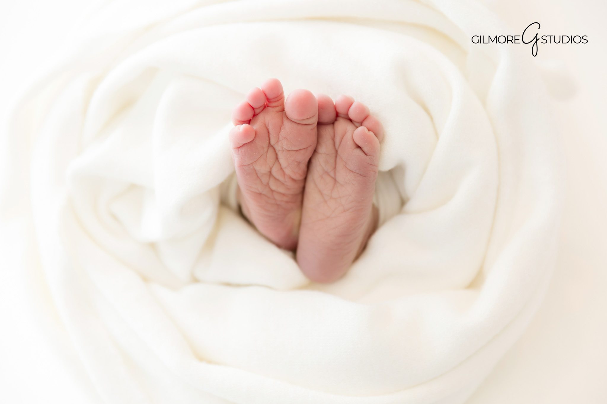 Newborn photography capturing baby’s first winter
Newborn baby photographed with cozy textures