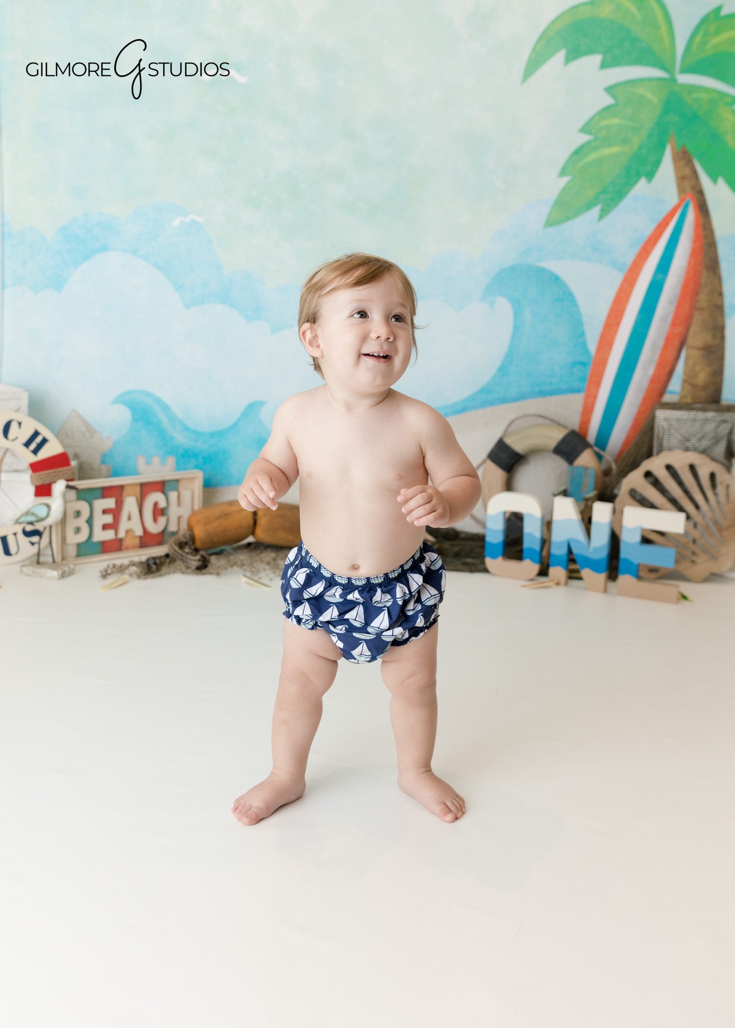 Coastal themed cake smash photography for one year old in Orange County
First birthday milestone portraits with ocean colors in Orange County studio