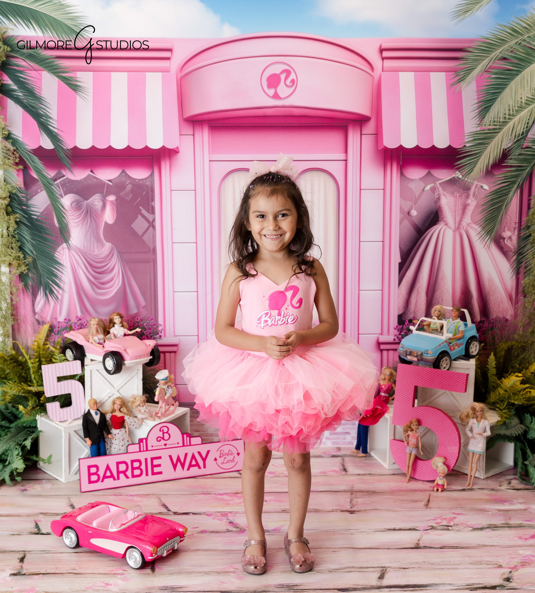 Barbie themed child portrait photography with bold pink colors

5th birthday milestone photography portrait for stylish young girl