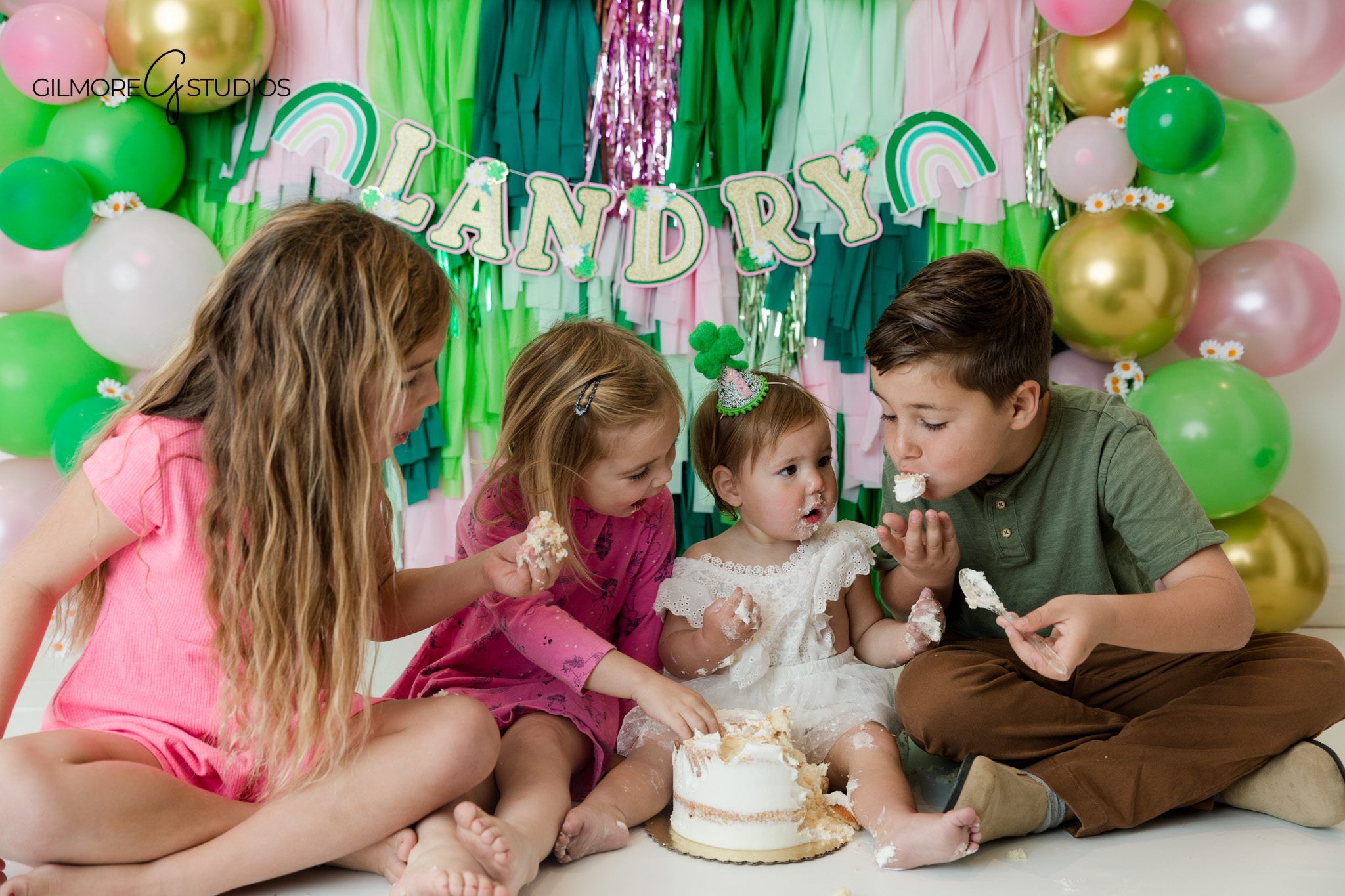 cake smash portrait photographer baby interacting with cake
first birthday cake smash photography baby girl studio setup portrait