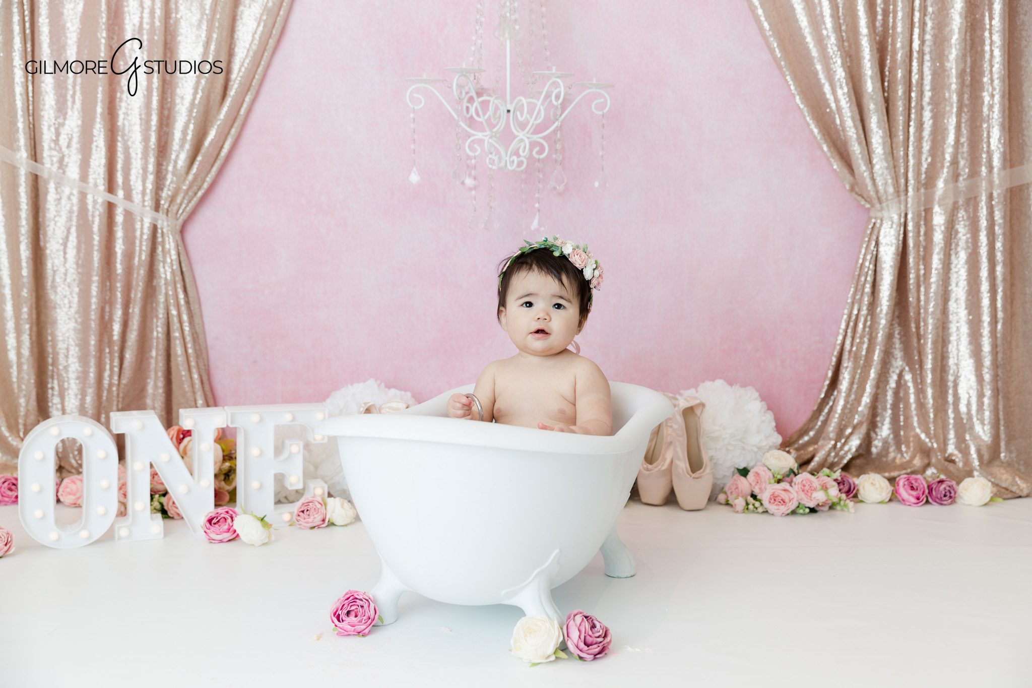 first birthday portrait photography baby girl cake smash pink tones
Newport Beach cake smash photography baby girl sitting with cake portrait