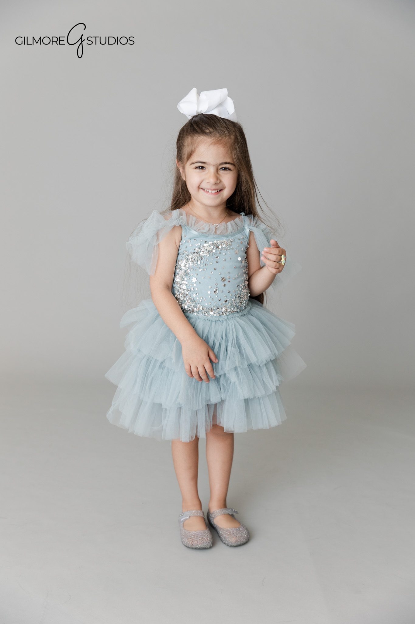 Child portrait photography capturing playful expression

Kids birthday photography showing child twirling in dress