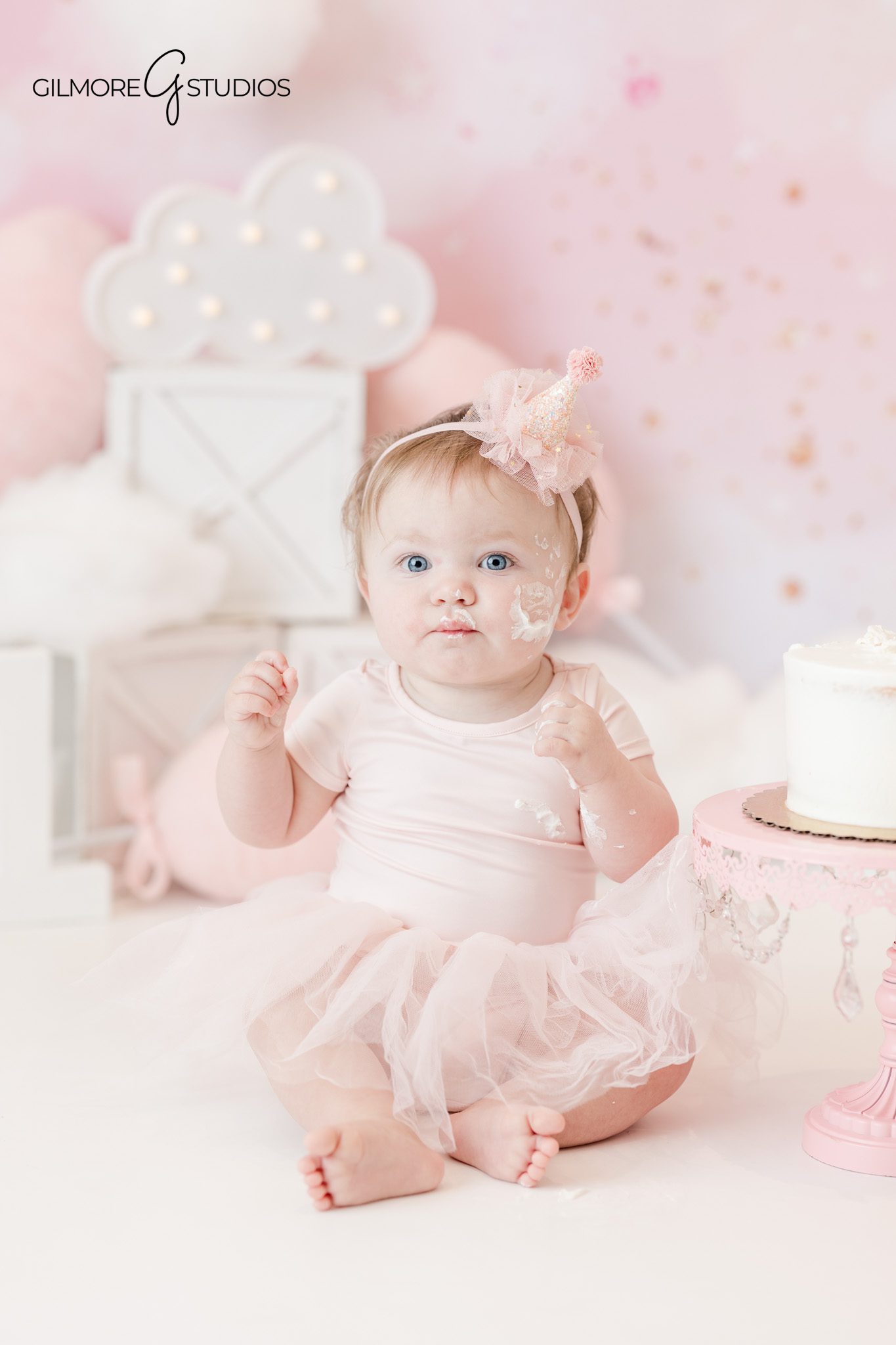 Cake smash photography showing baby exploring cake

Baby portrait photographed during milestone photography session