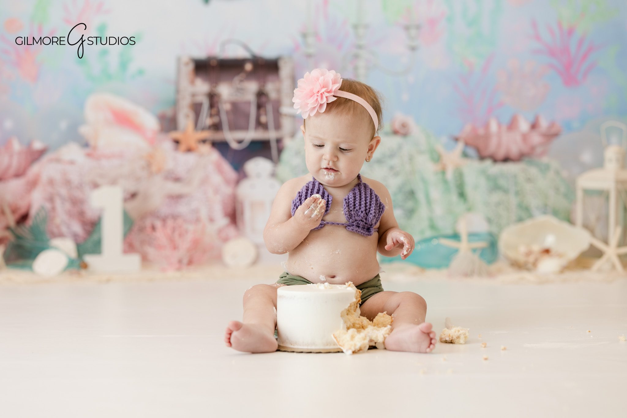 Cake smash photography showing baby exploring cake

Baby portrait photography capturing first birthday moment