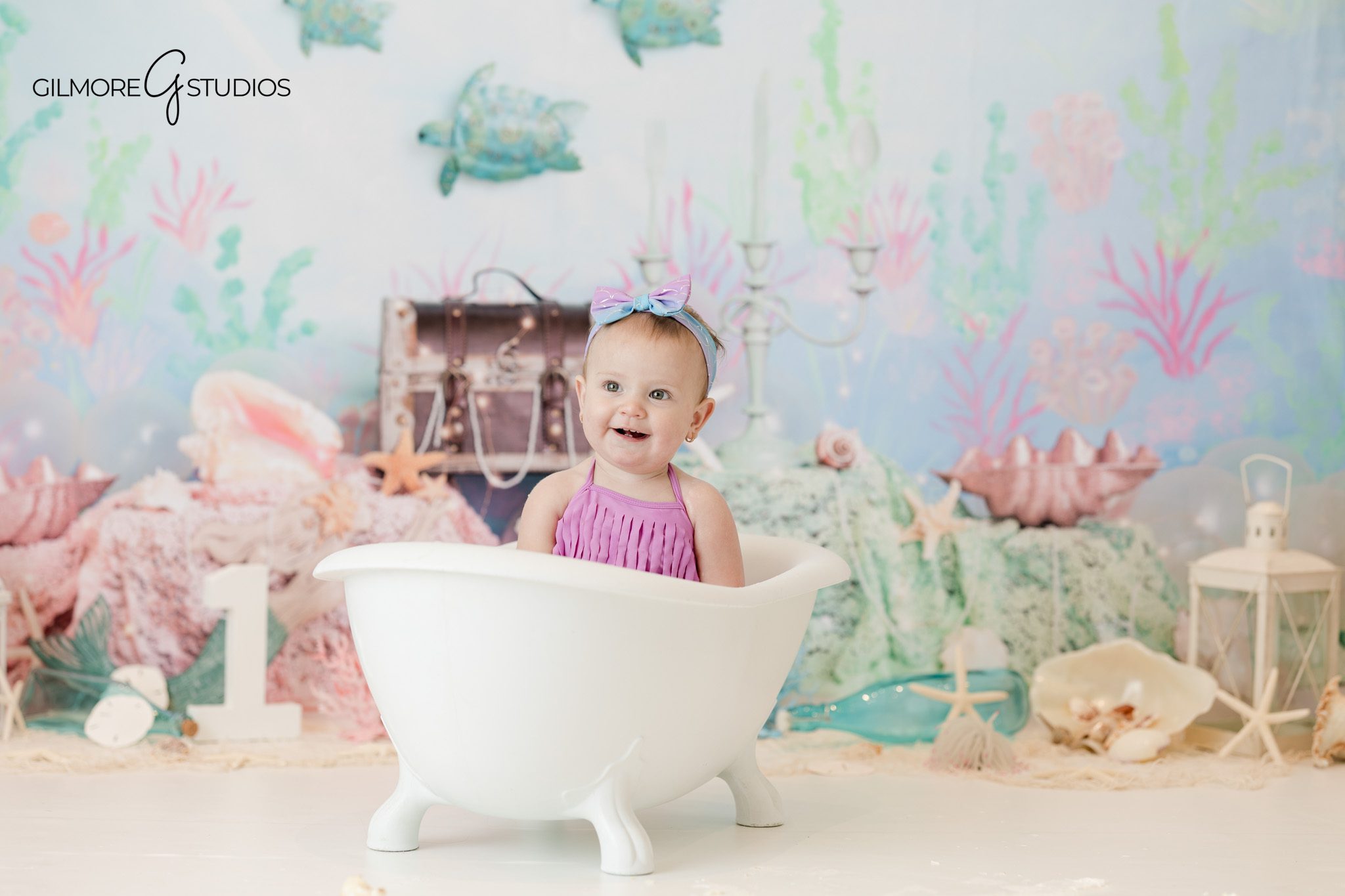 First birthday portrait photographed by baby photographer

Cake smash photography portrait showing baby touching frosting