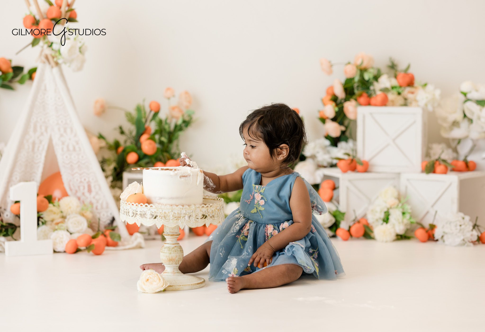 Cake smash photography showing baby exploring cake
Baby milestone portrait photography session