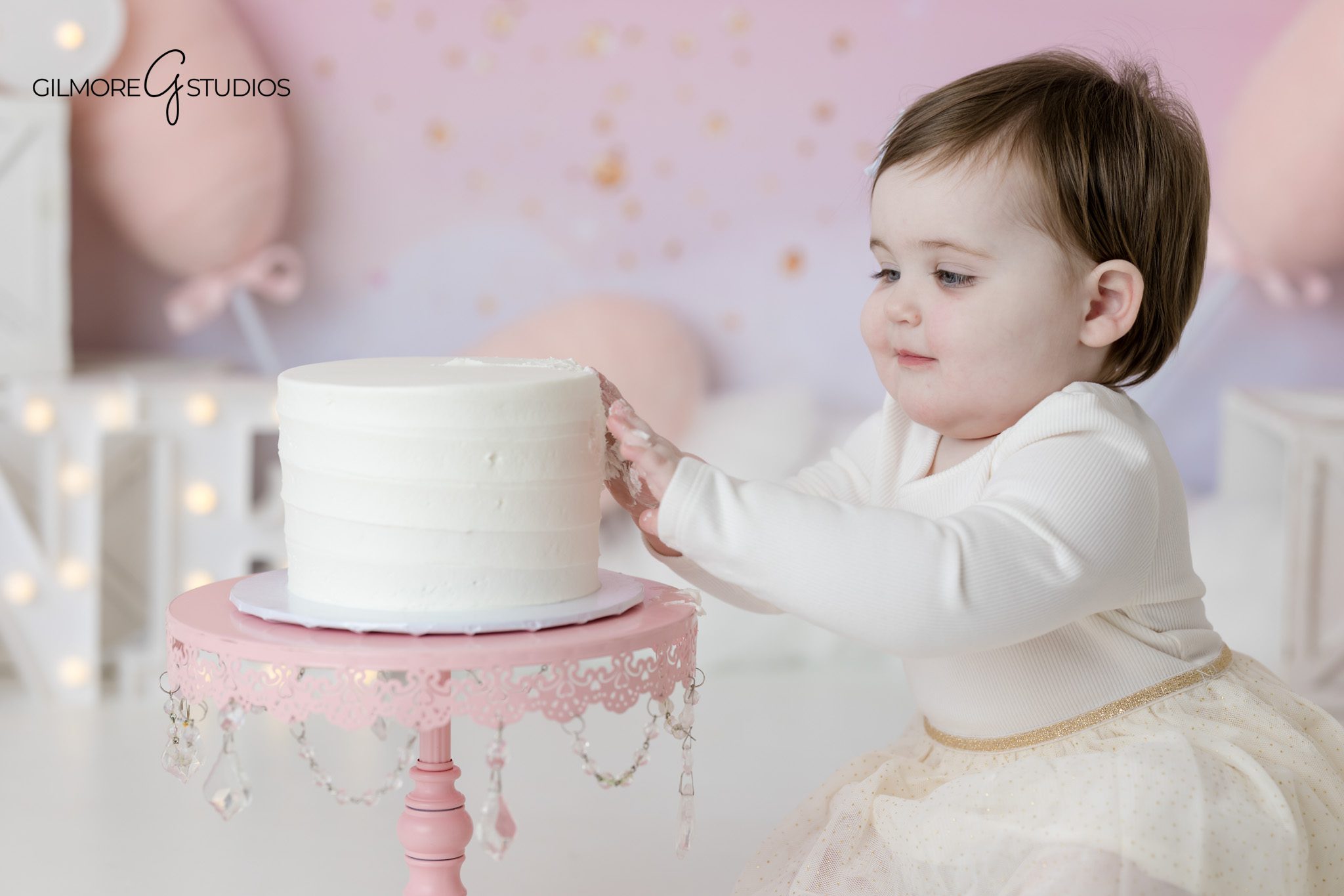 Baby portrait photography with birthday theme

Cake smash photography showing baby exploring cake