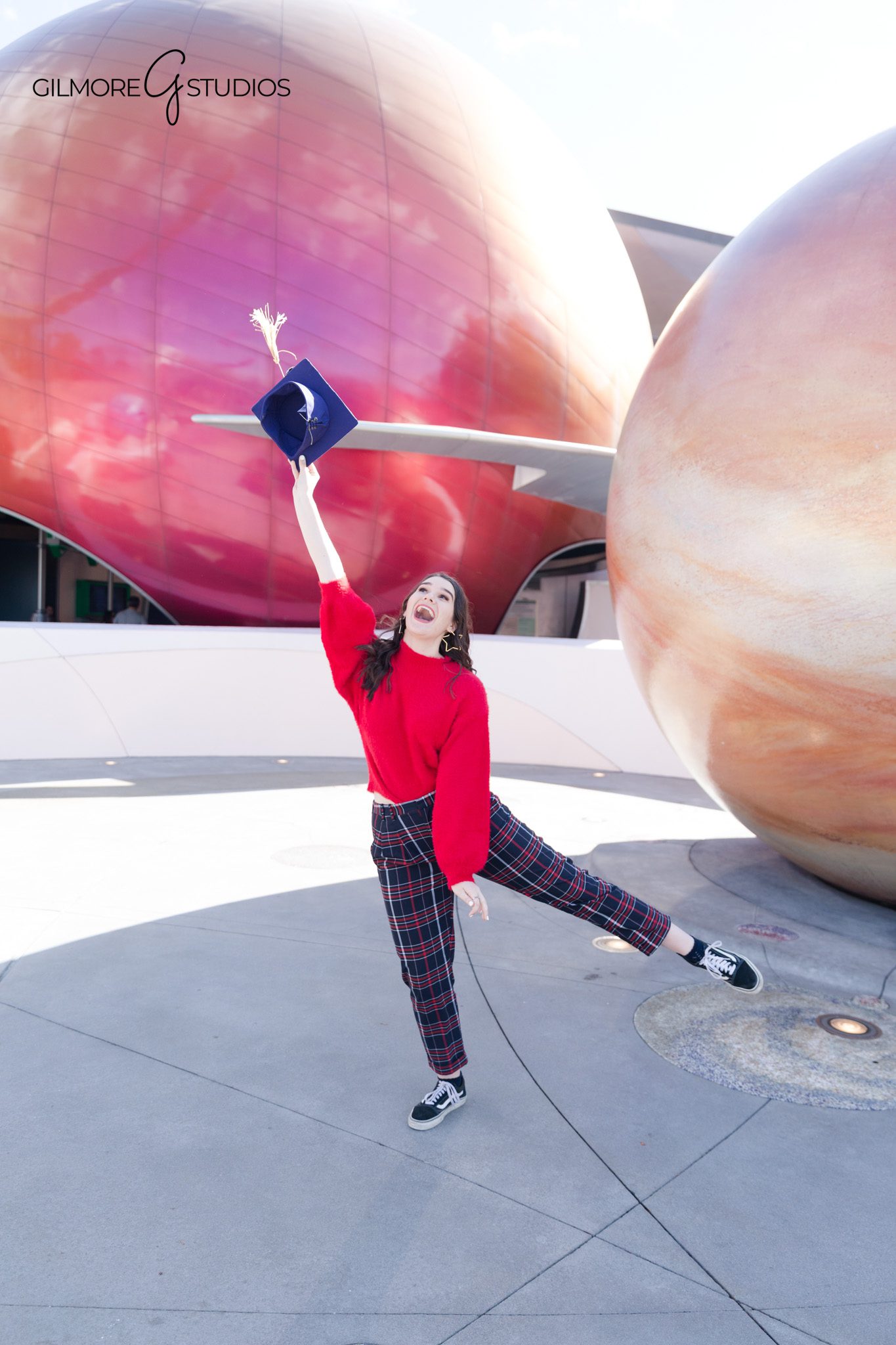 Senior holding Mickey ears candid moment
Disney senior photos playful personality