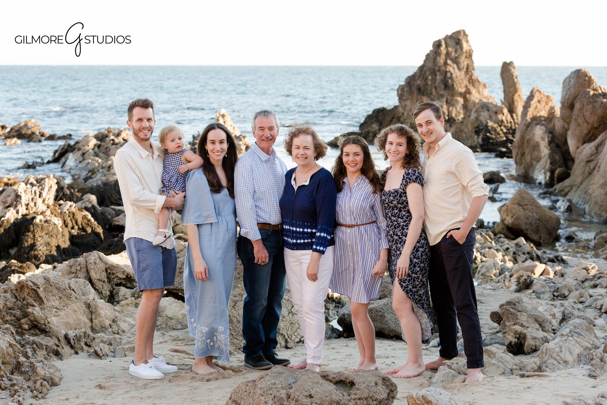 Family hugging on beach Newport Beach natural light photography
Newport Beach family photos candid playful beach session