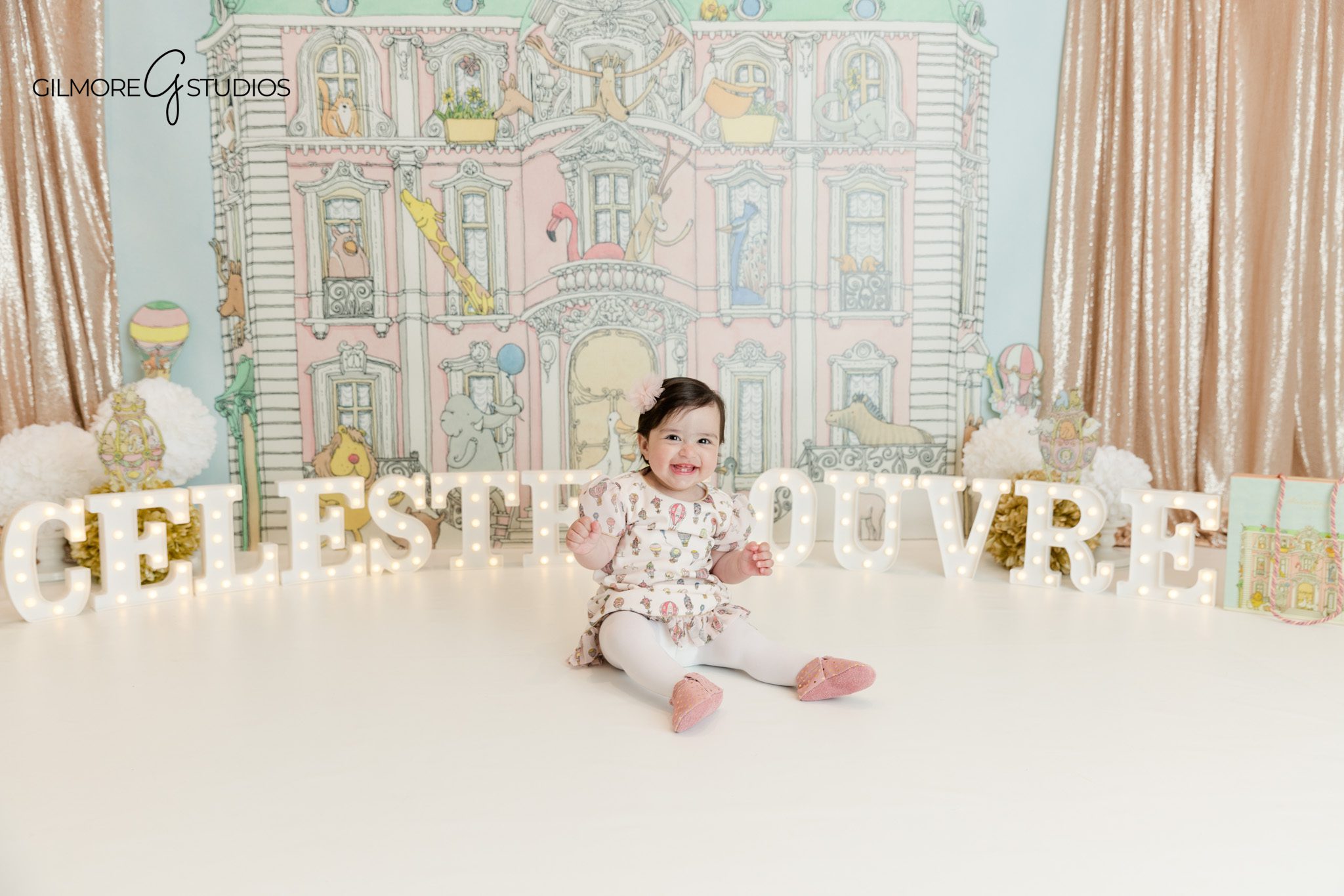 Baby girl reaching for cake during cake smash session Phoenix
Phoenix studio cake smash session with custom birthday setup