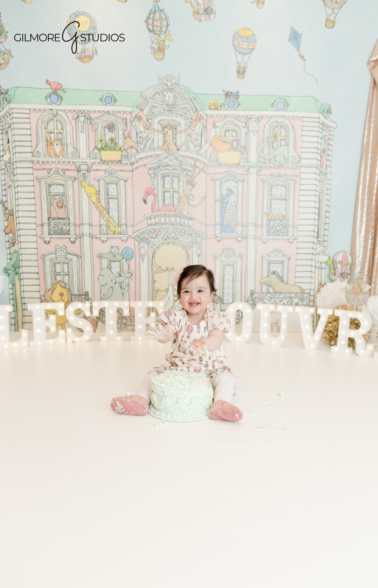 Phoenix cake smash photographer first birthday studio session
Baby smiling during cake smash photoshoot Phoenix Arizona