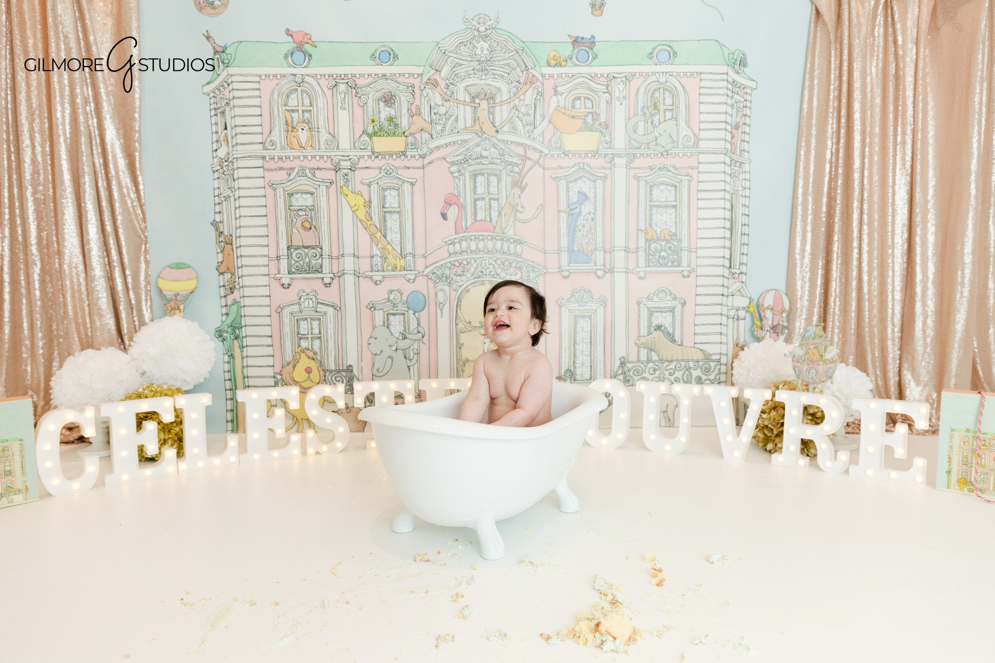 Baby girl playing with cake during smash session Phoenix
Phoenix indoor baby photoshoot cake smash milestone