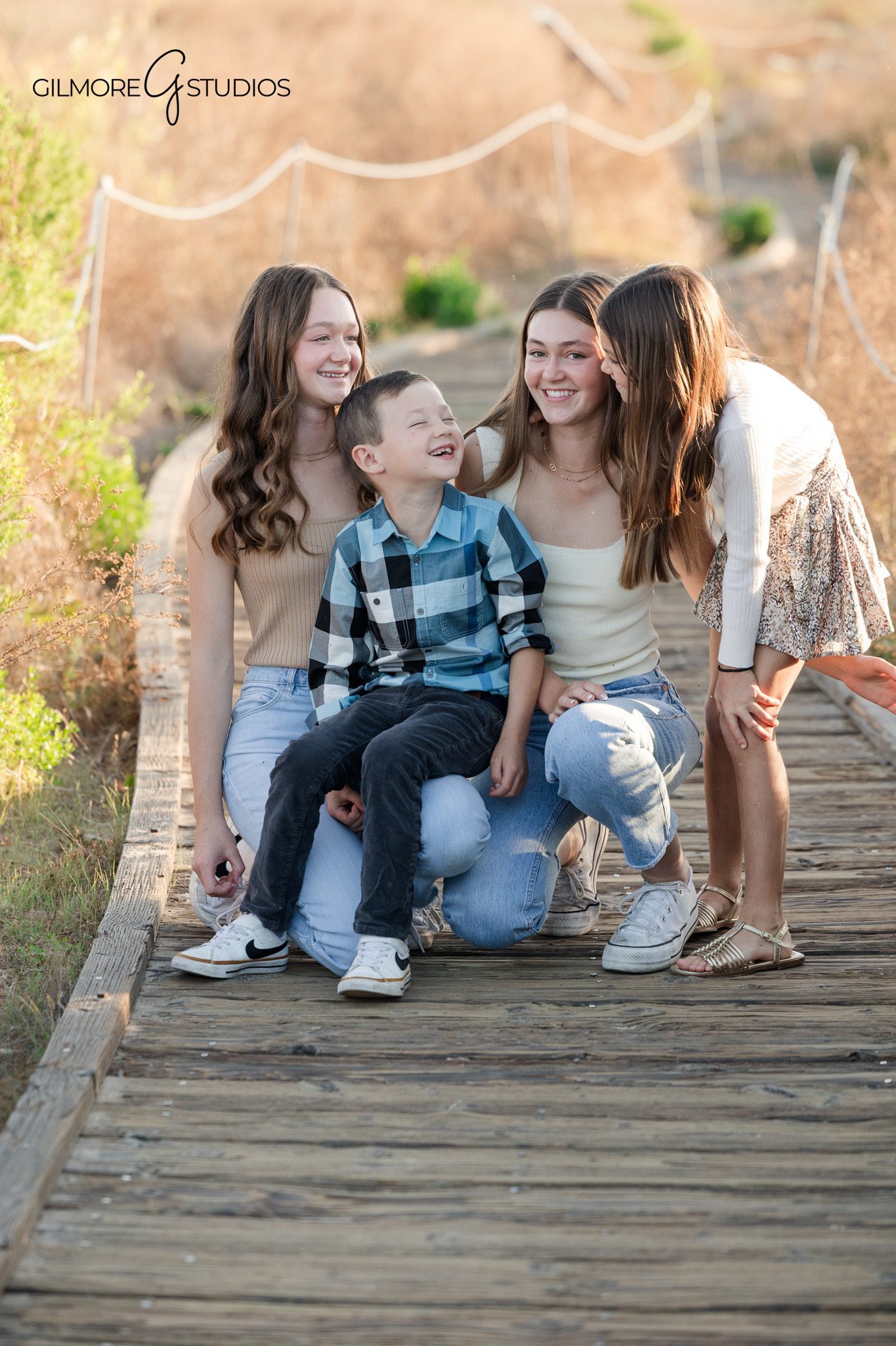 newport coast family photographer capturing family walking together candid
crystal cove photography session with parents and children golden hour