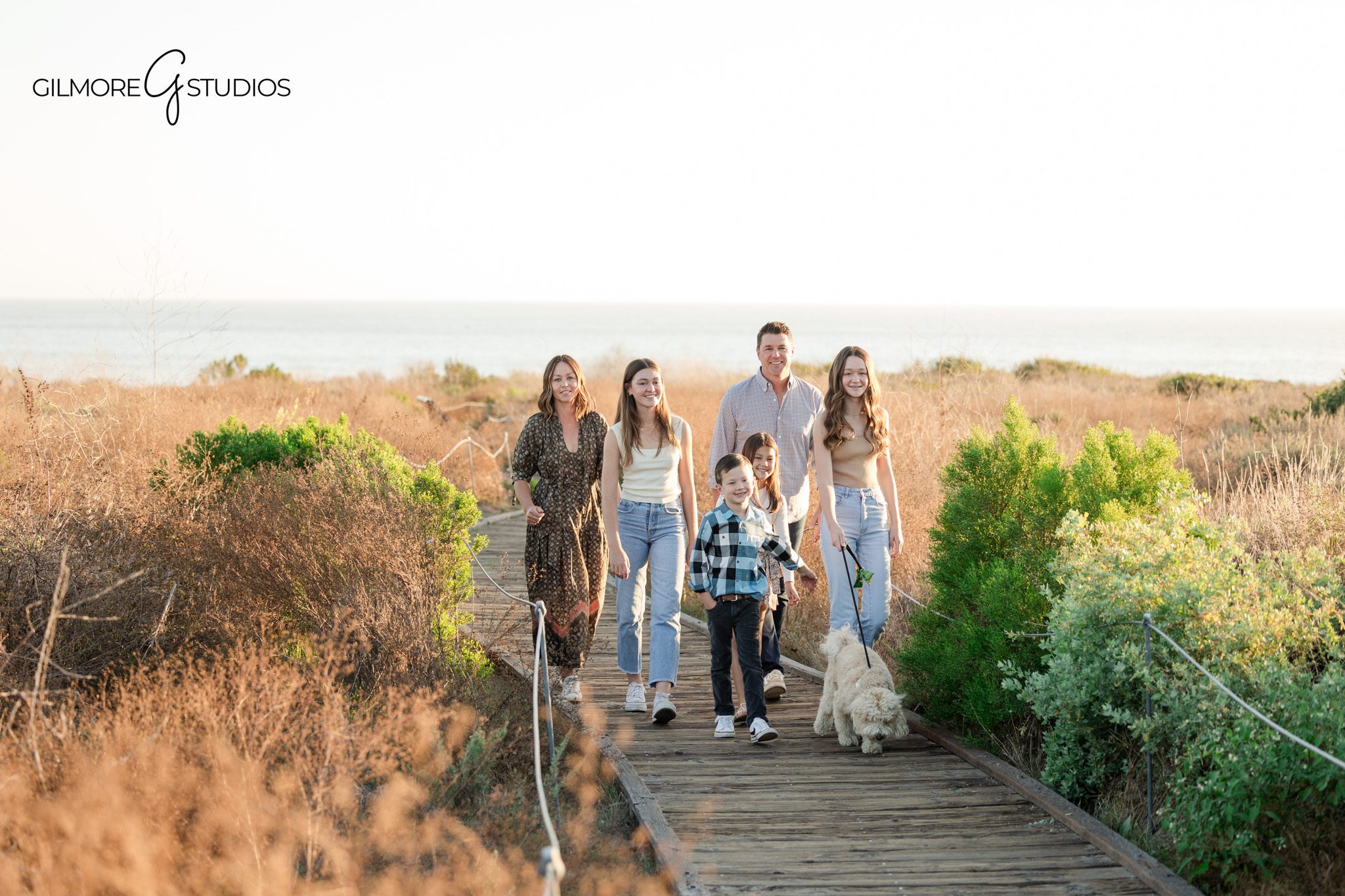 crystal cove state park family photographer capturing playful candid moments
family photos with dog newport beach california coastal trail photography