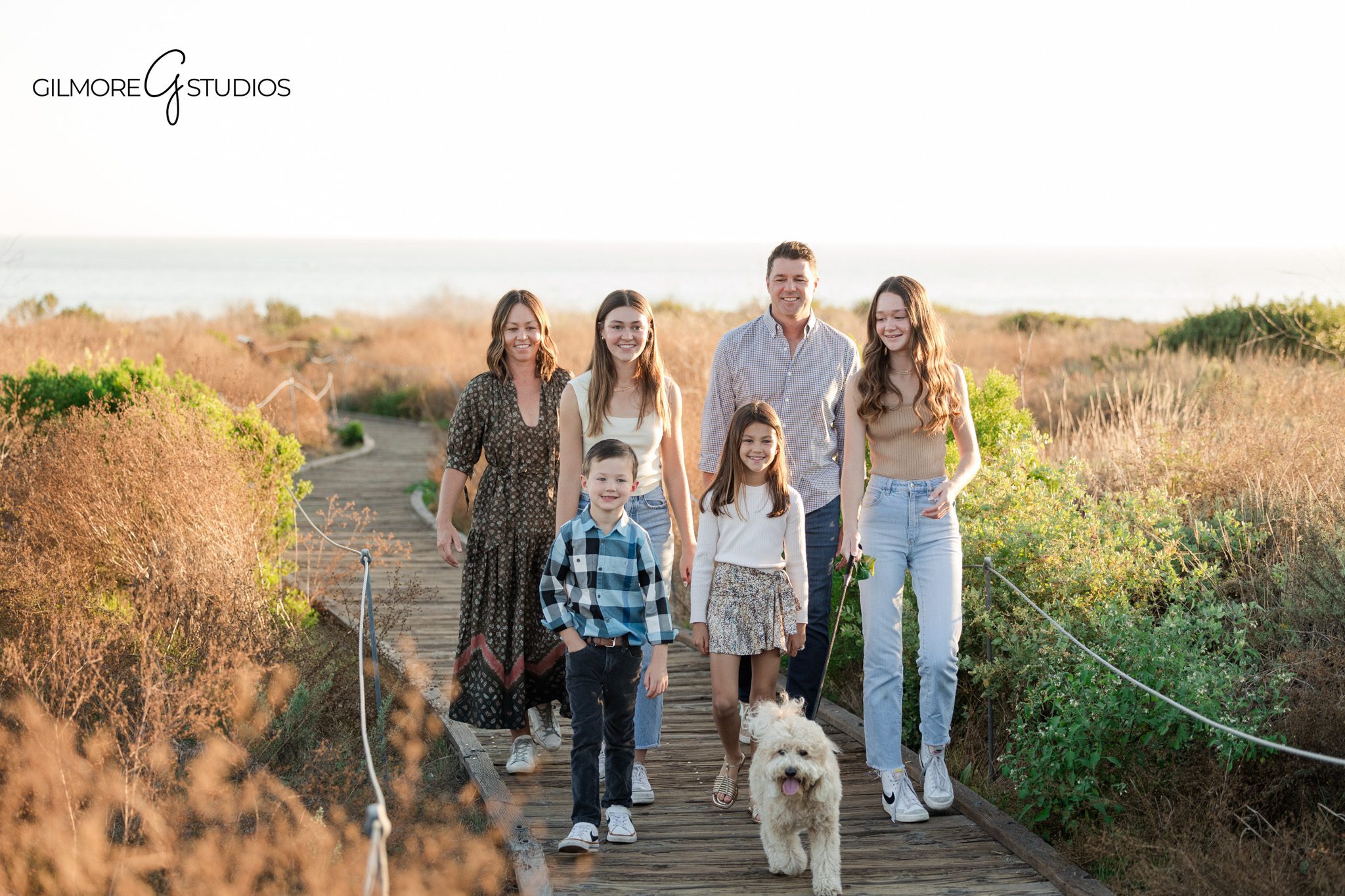 orange county family photography session with relaxed natural posing outdoors
crystal cove golden hour family portrait session warm light photography