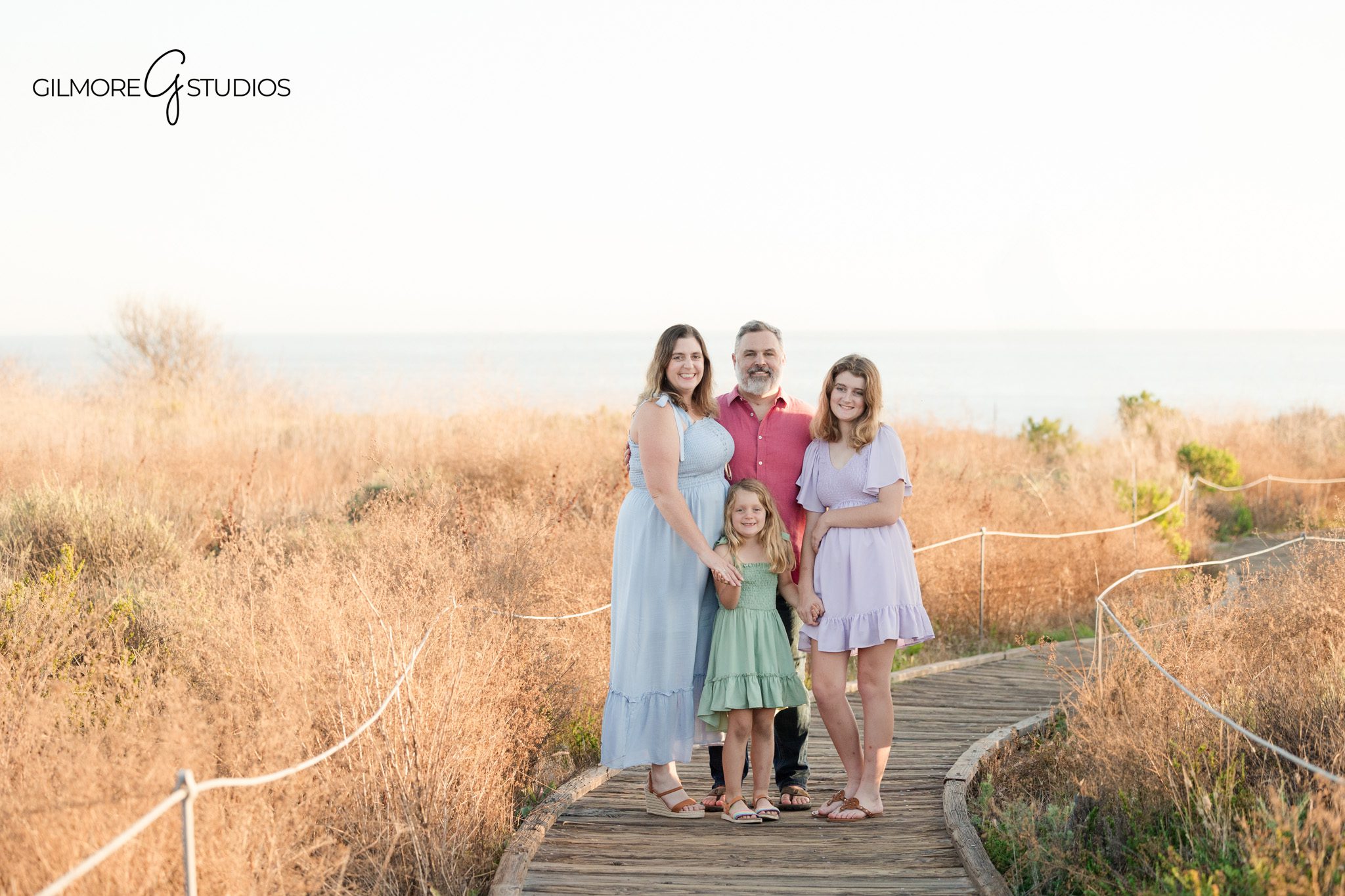 Family walking on beach Newport Beach golden hour portraits
Orange County family photographer beach session Newport Beach