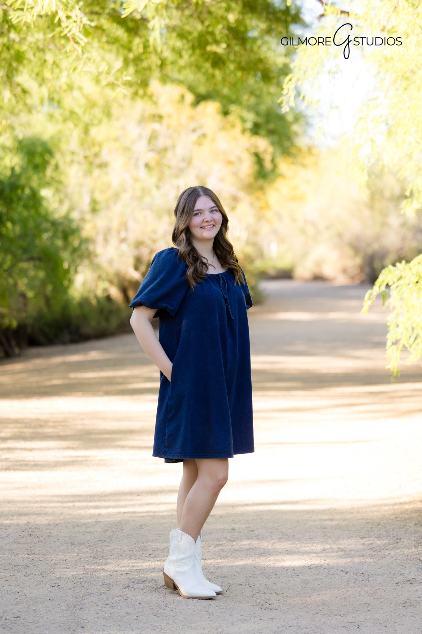 Senior girl posing by wooden fence Gilbert Arizona photoshoot
Senior pictures Riparian Preserve Gilbert AZ scenic nature location
