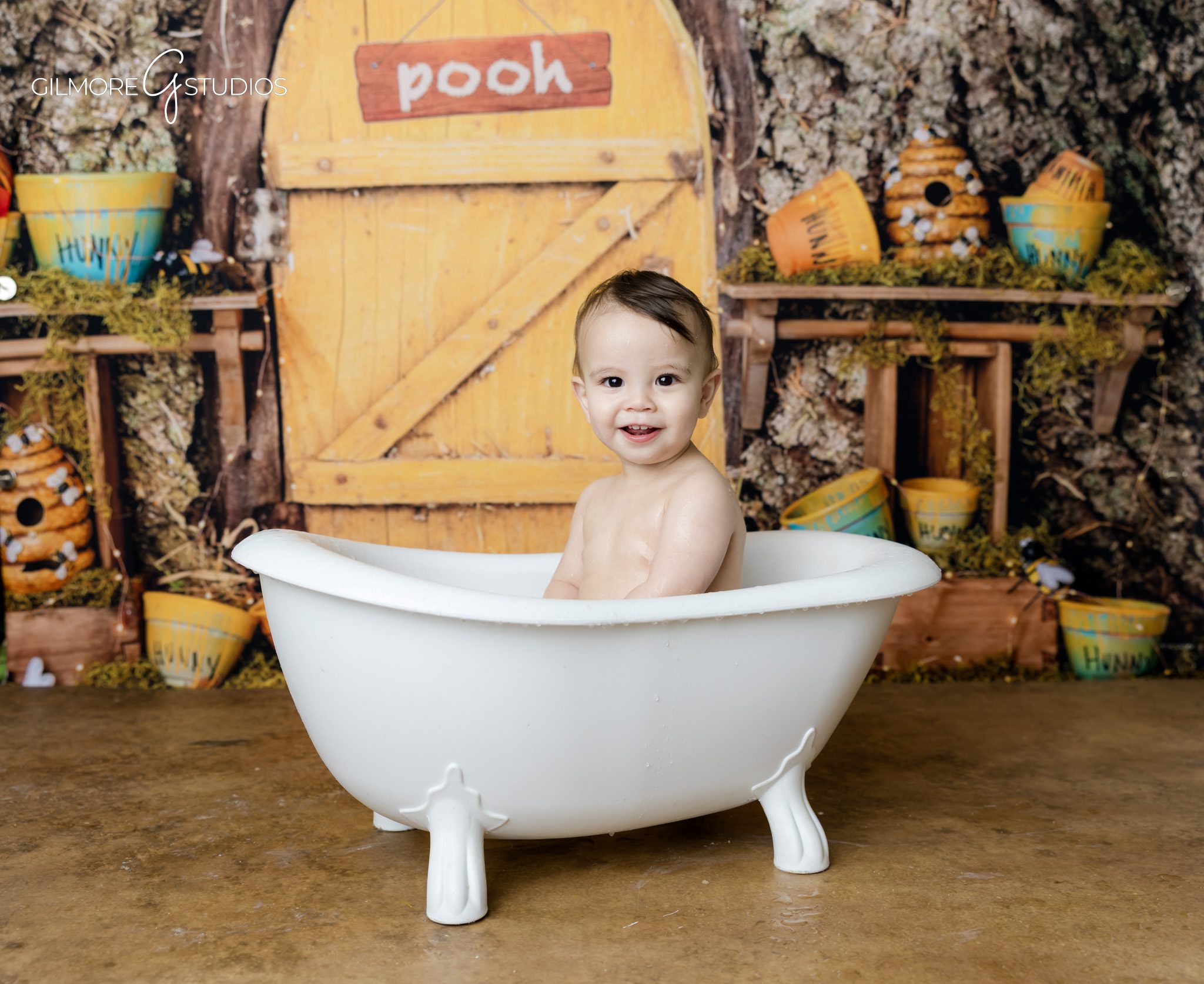 Winnie the Pooh cake smash baby smiling with frosting
Gilbert AZ baby photographer cake smash candid moments