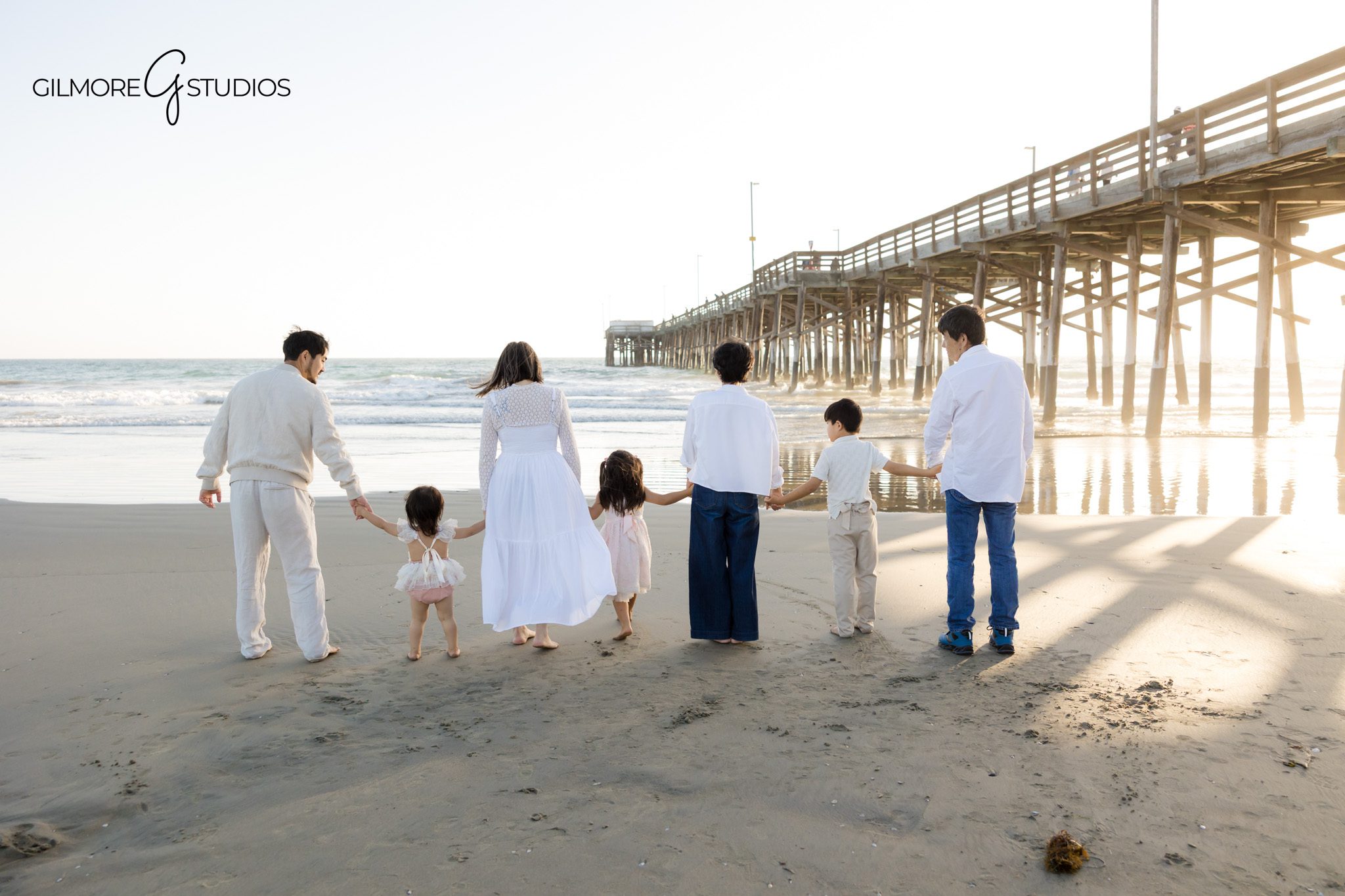 Family laughing together near Newport Pier
Natural family interaction beach photography