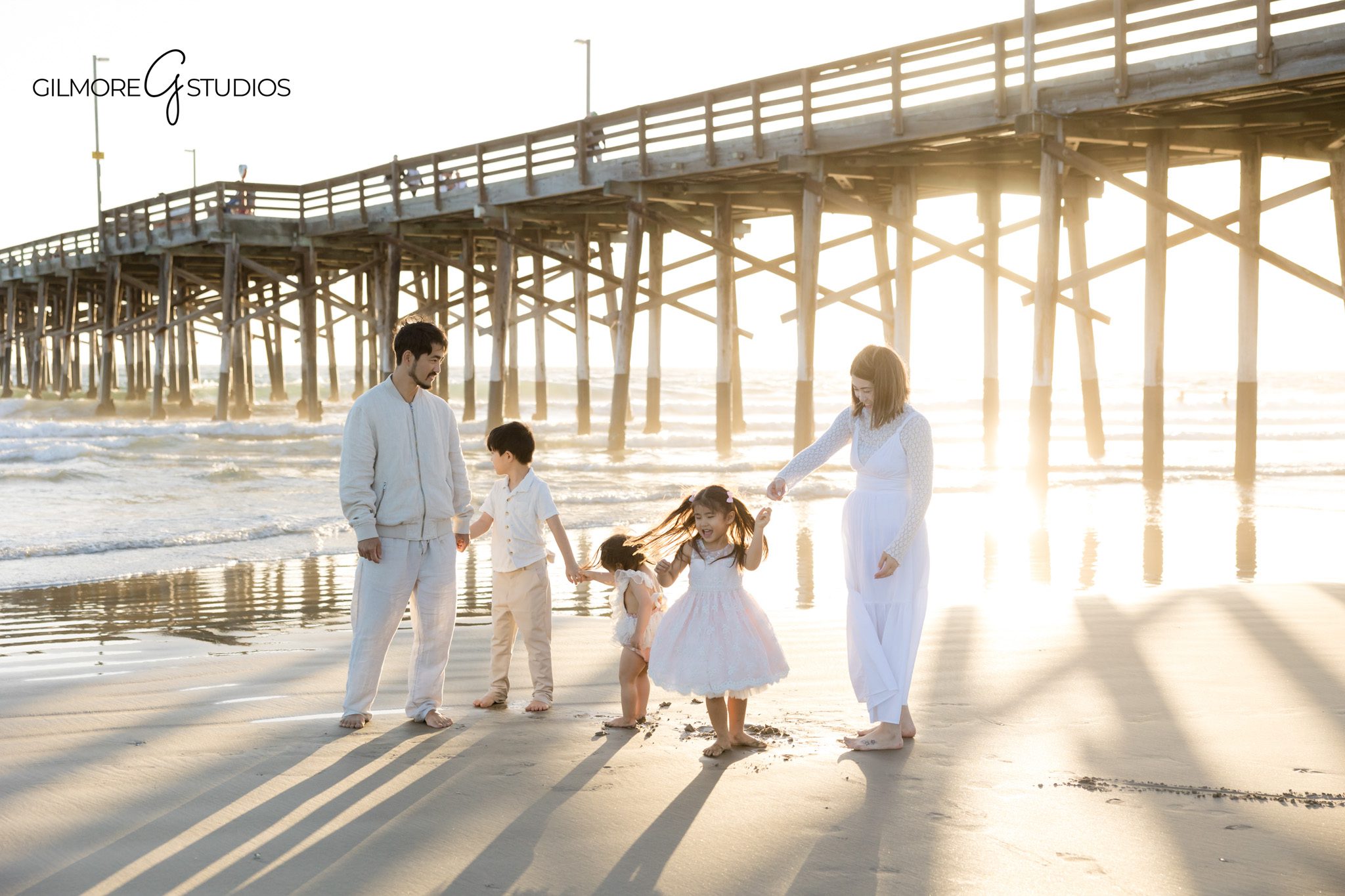 Family portrait near ocean waves Newport Beach
Beach family photo calm water reflection